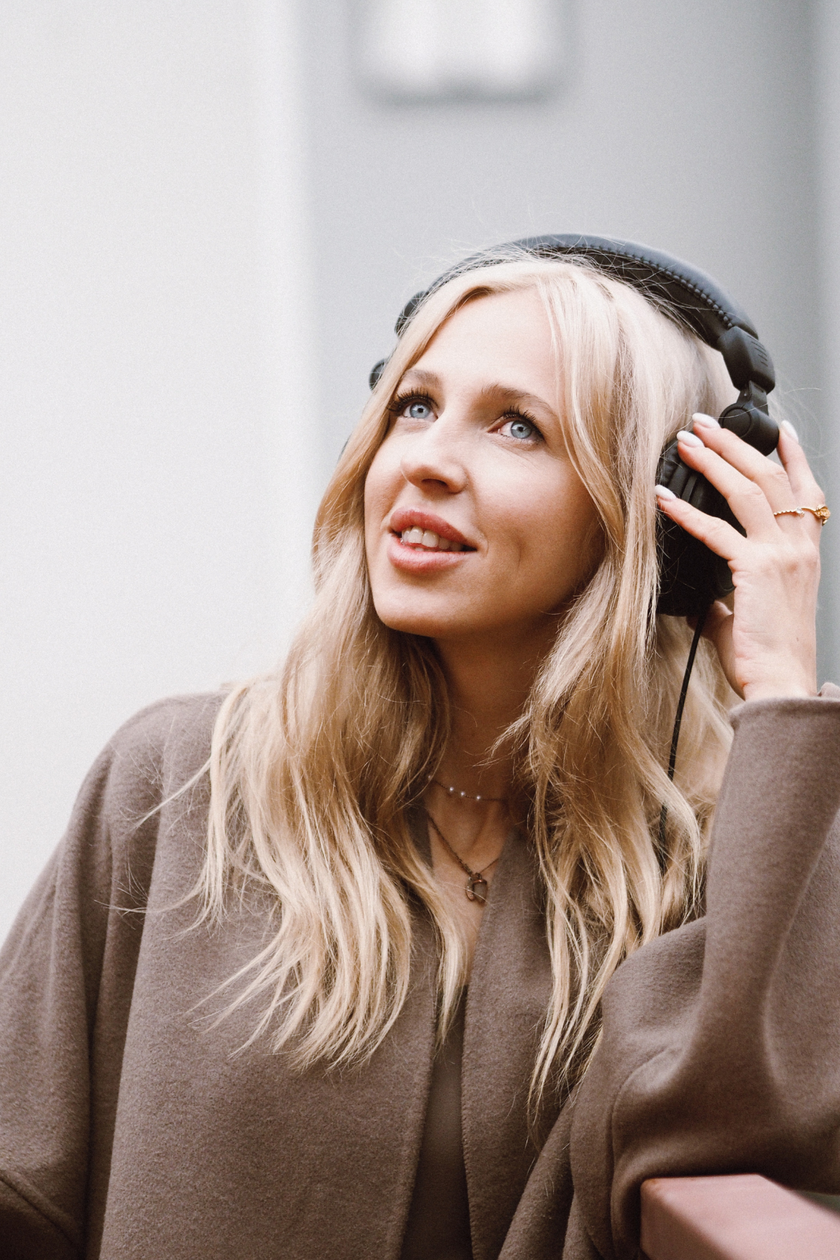 Woman listening to The Building Well Podcast with Amanda Magho for female entrepreneurs looking for motivation to stay in business and build sustainablly.