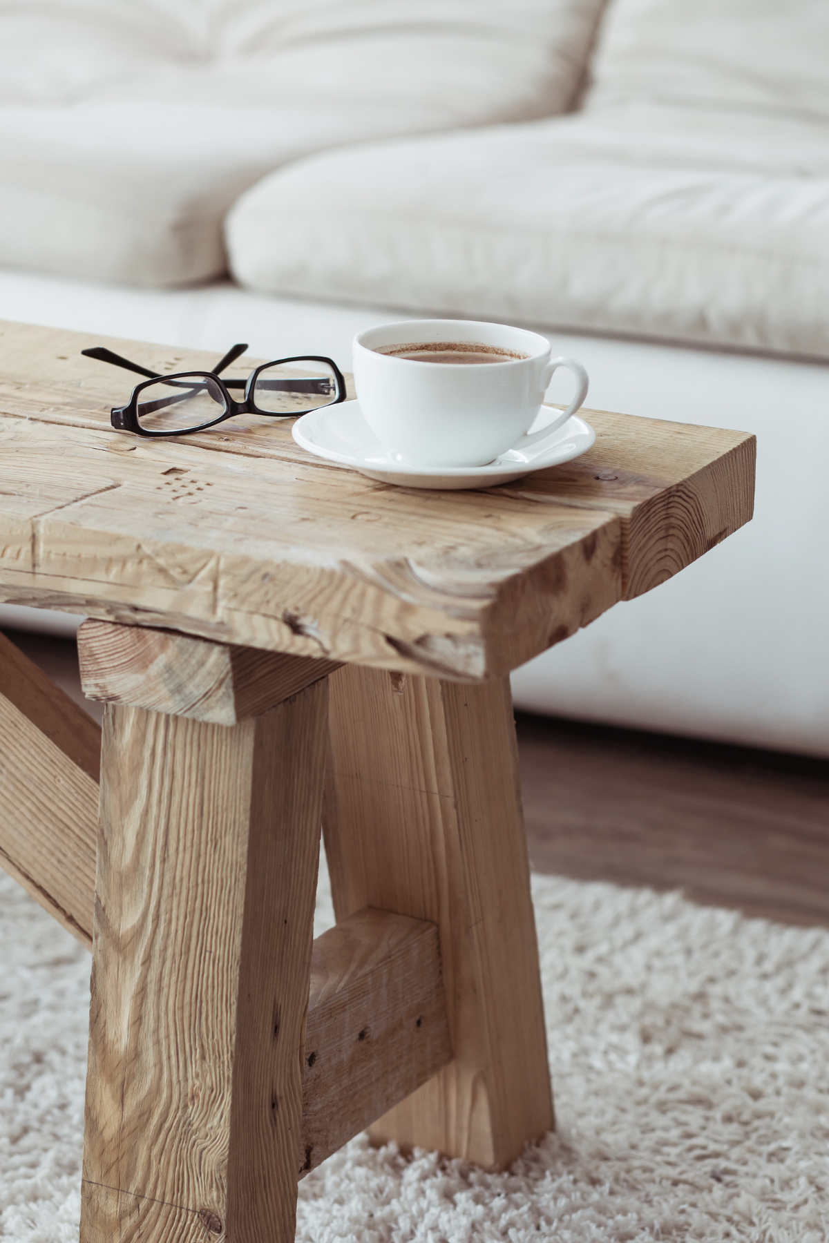 Coffee mug sitting on a desk inside the studio of The Building Well Podcast