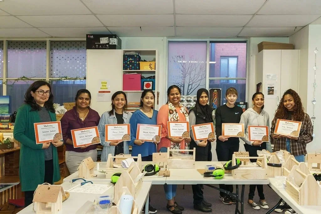 Educators holding certificates and wooden projects after completing a Little Woodworkers™ Professional Development workshops