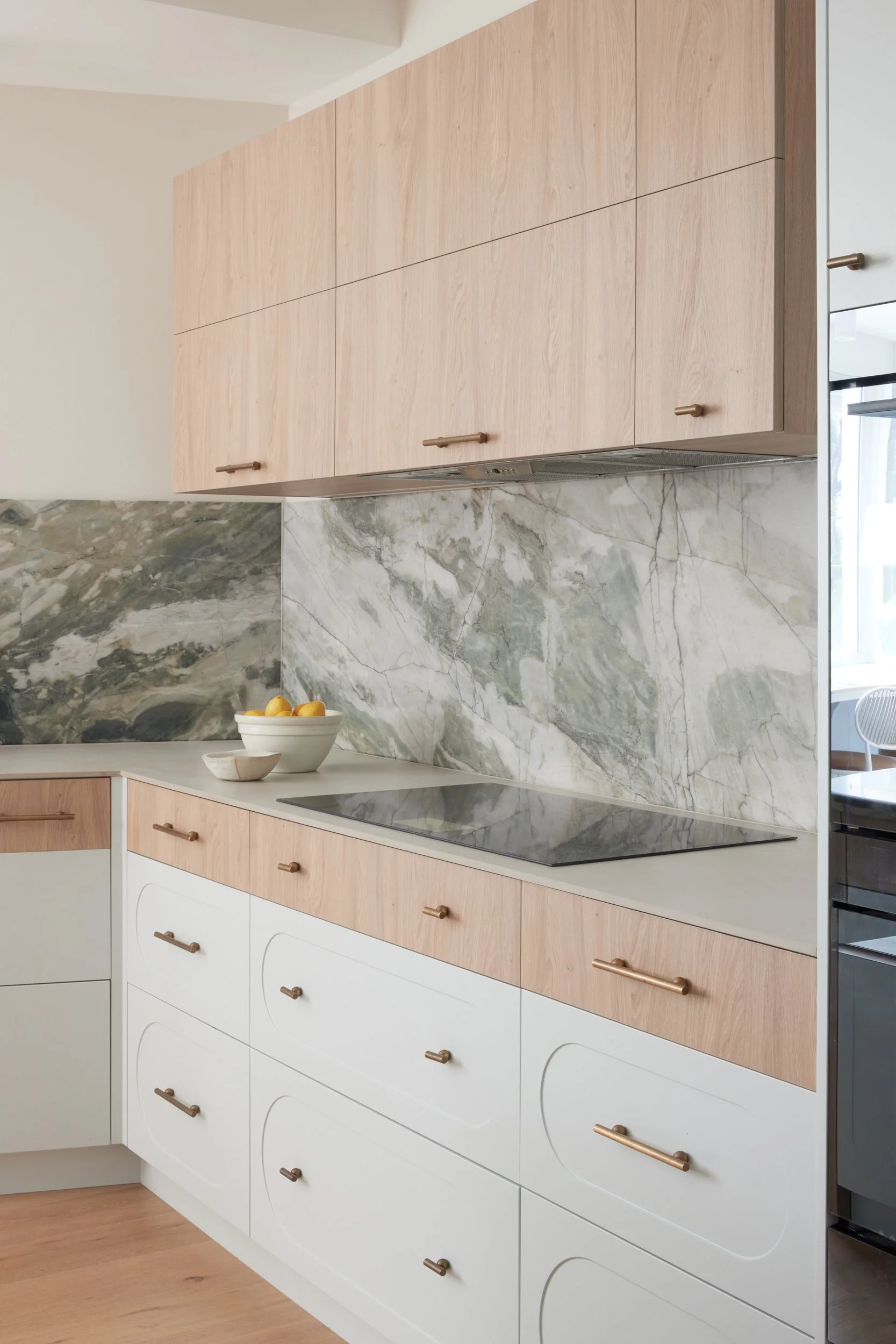 Kitchen joinery in timber veneer and tempest verde quartzite