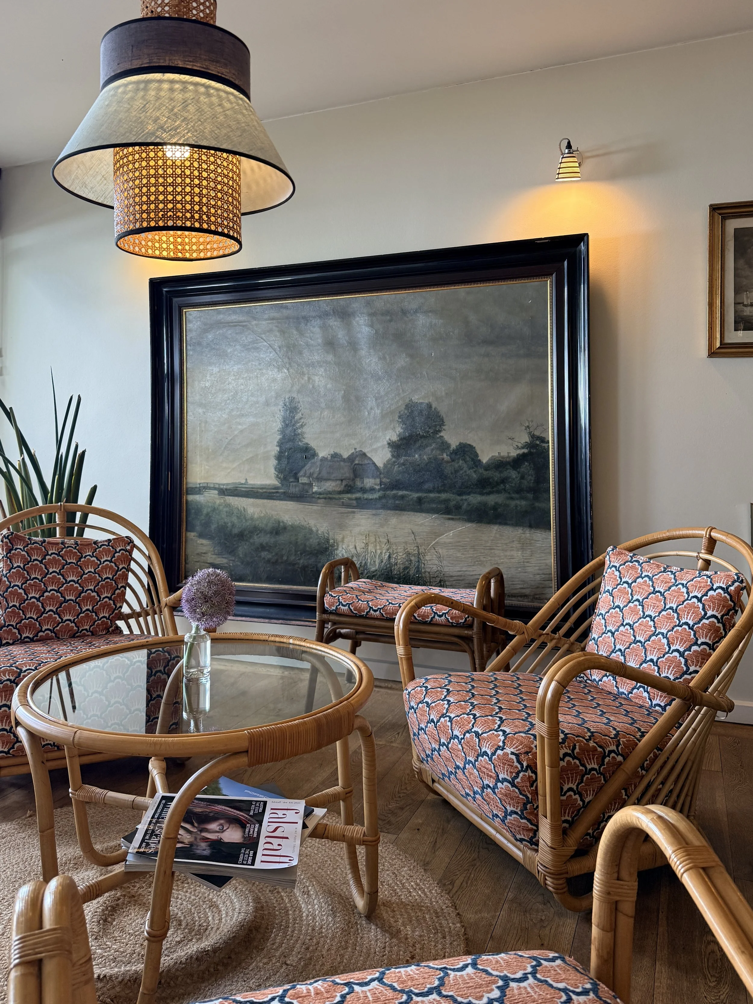 Inviting lounge with cane furniture and oversized artwork