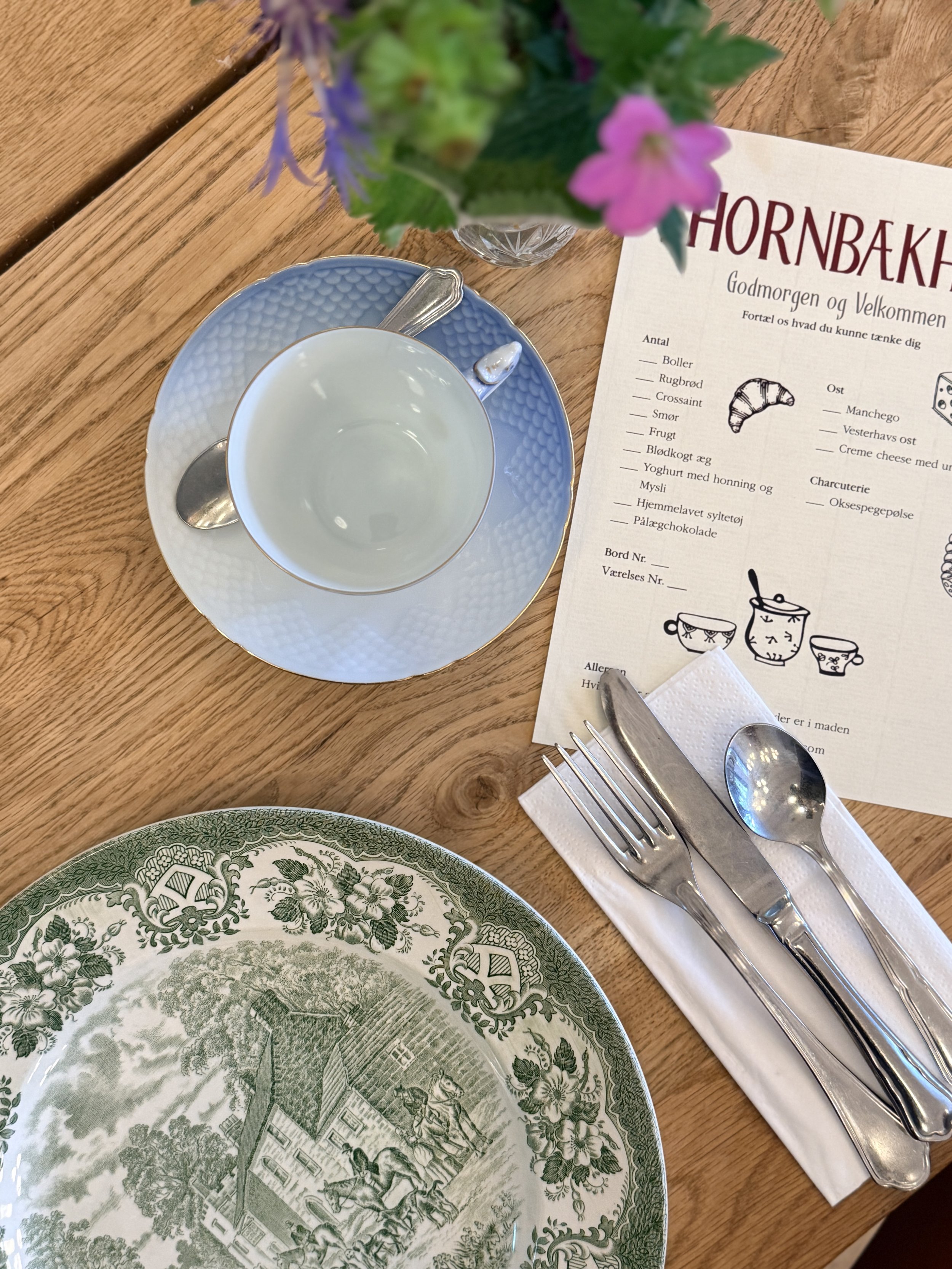 Danish place setting with mis-matched, patterned dishes