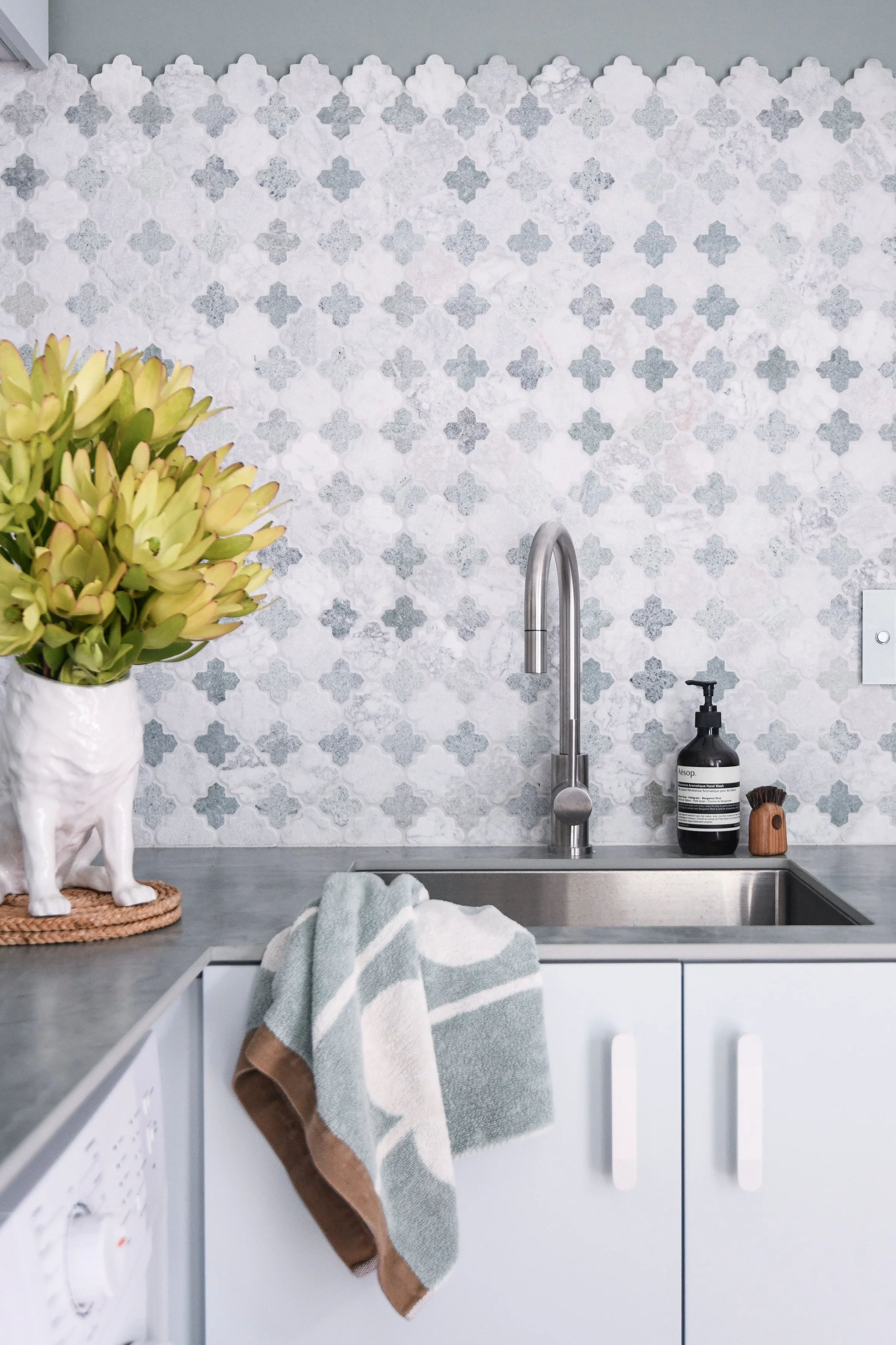 green and white marble tiles in a fresh laundry room
