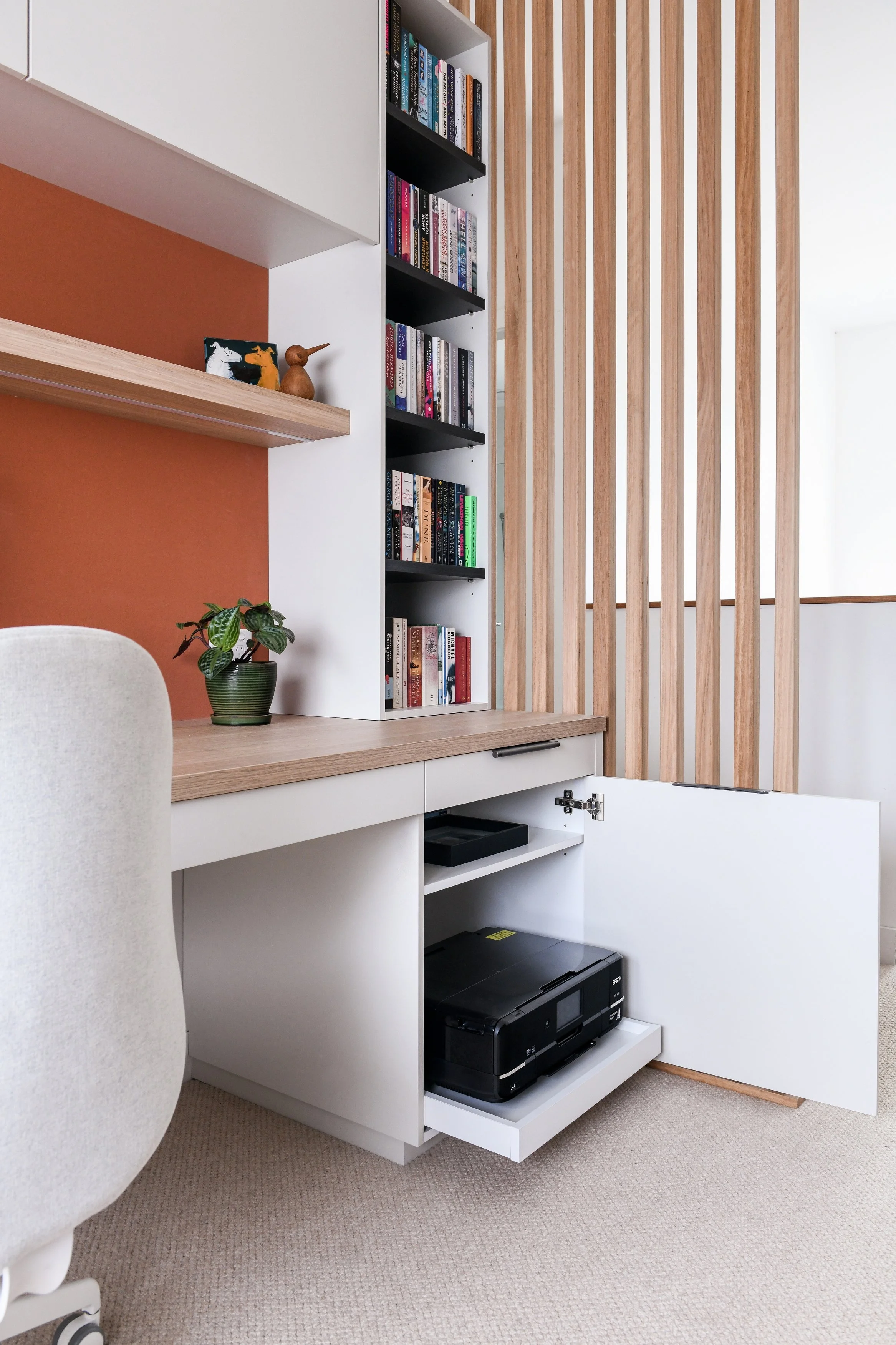 Home office desk with hidden printer drawer and mandarin coloured pinboard