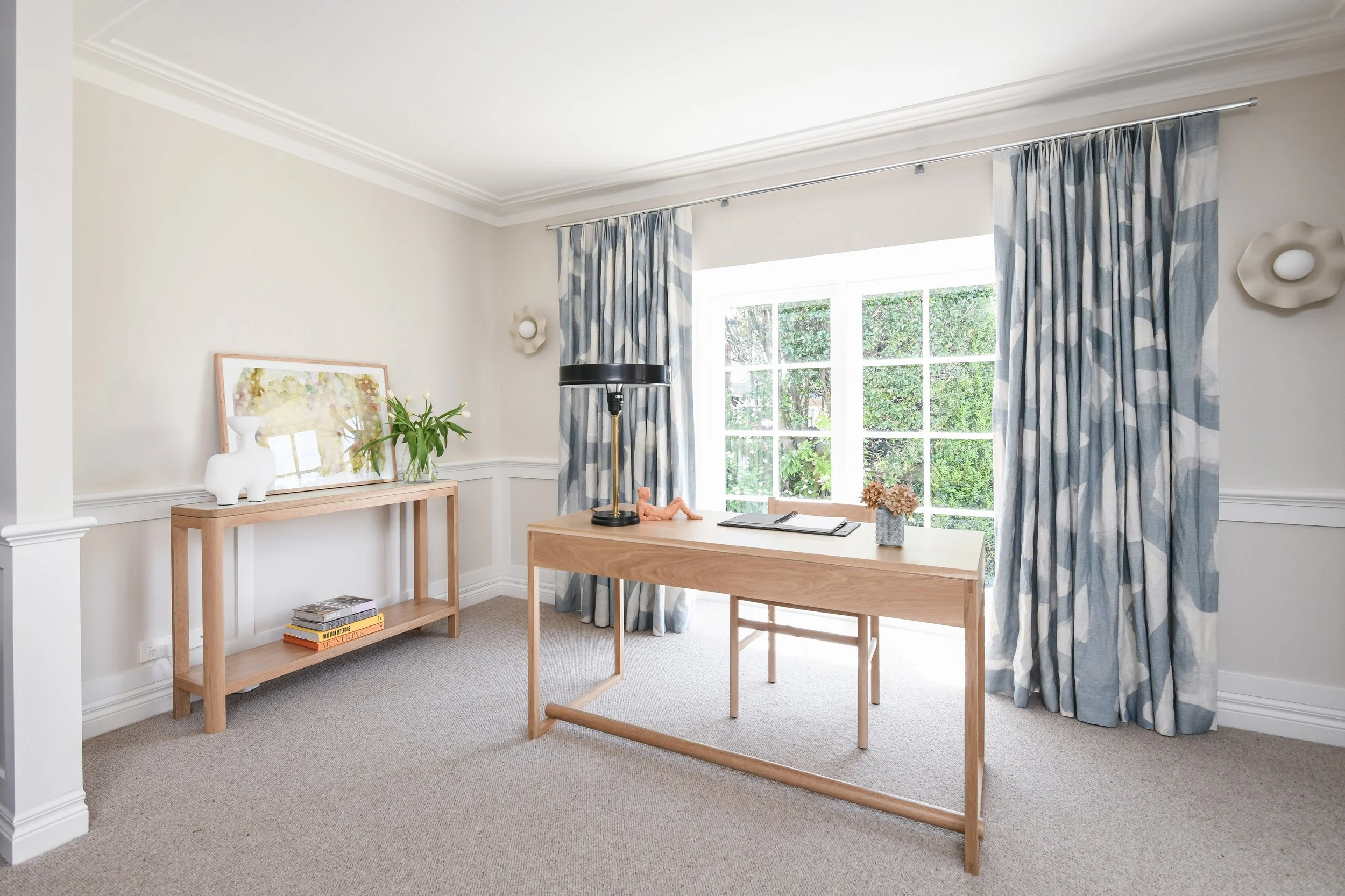 Serene home office with desk, console and garden view
