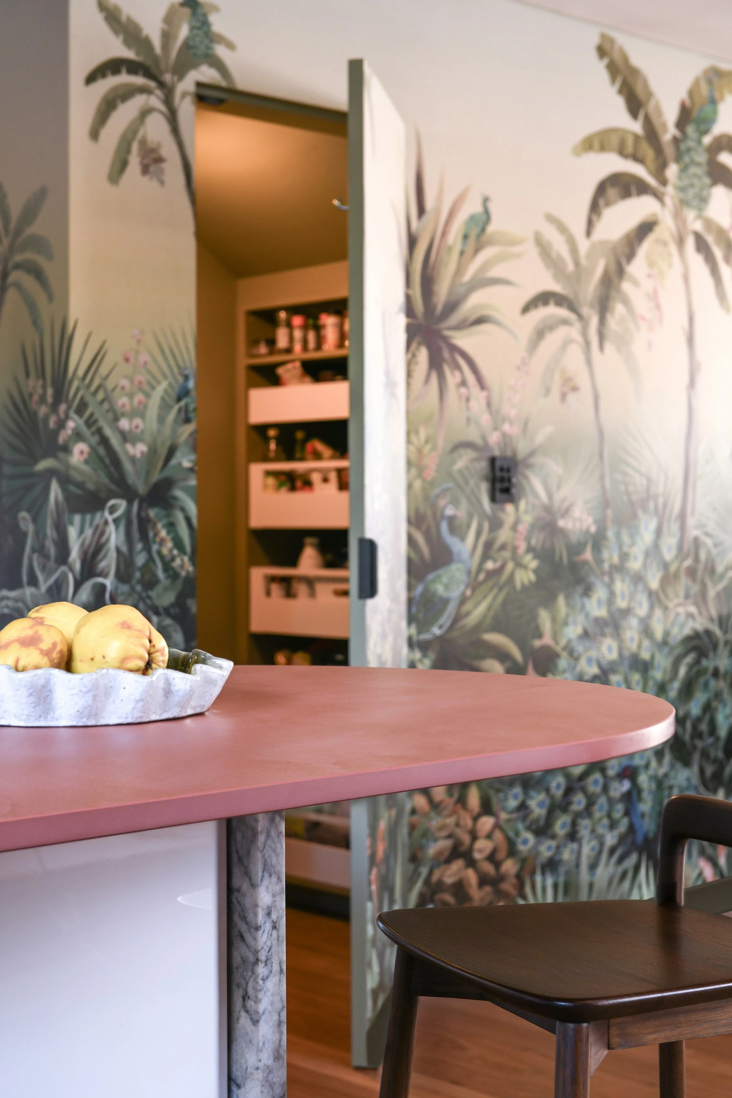 Pantry behind hidden door and wall mural