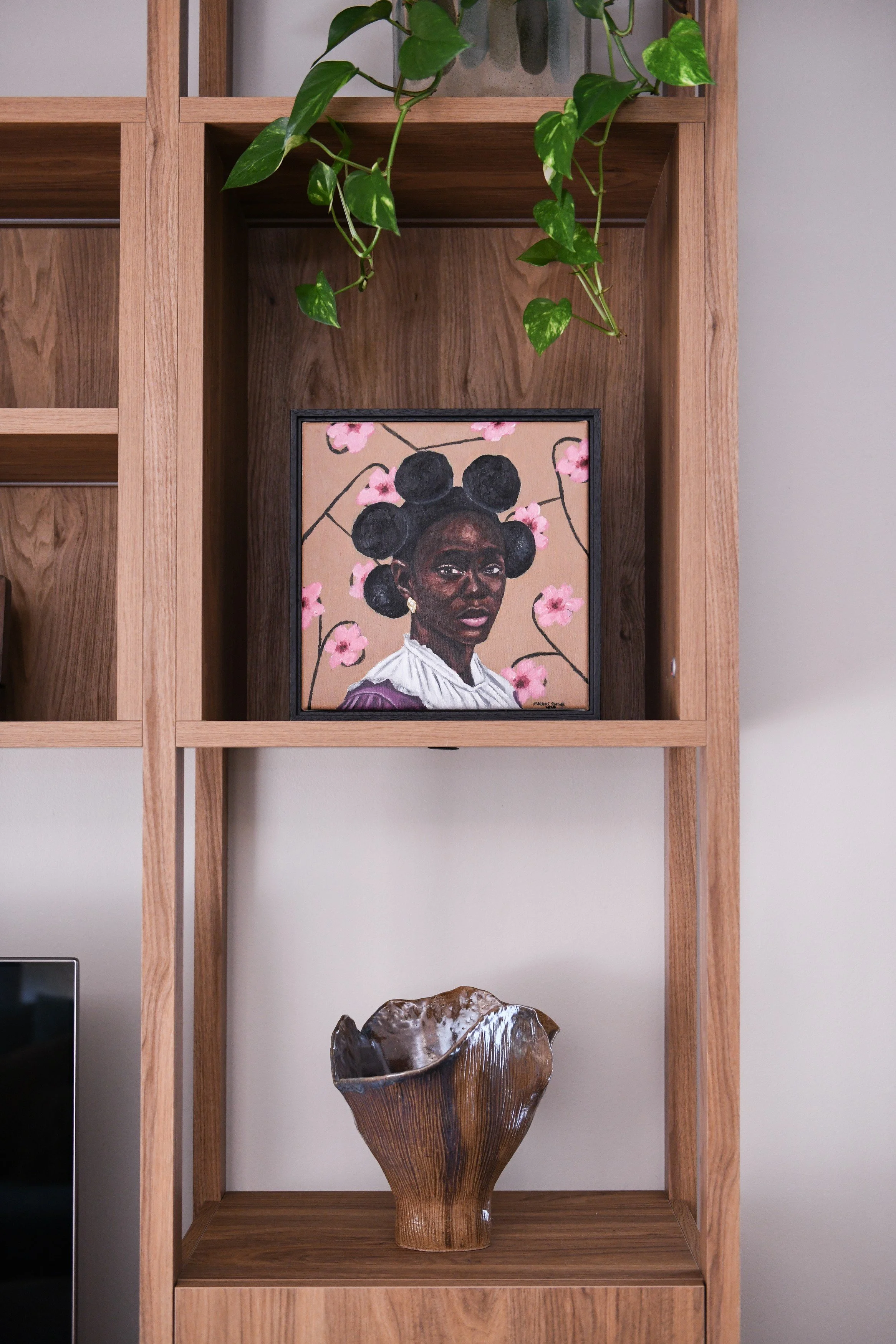 Timber display shelving with original artwork and ceramics