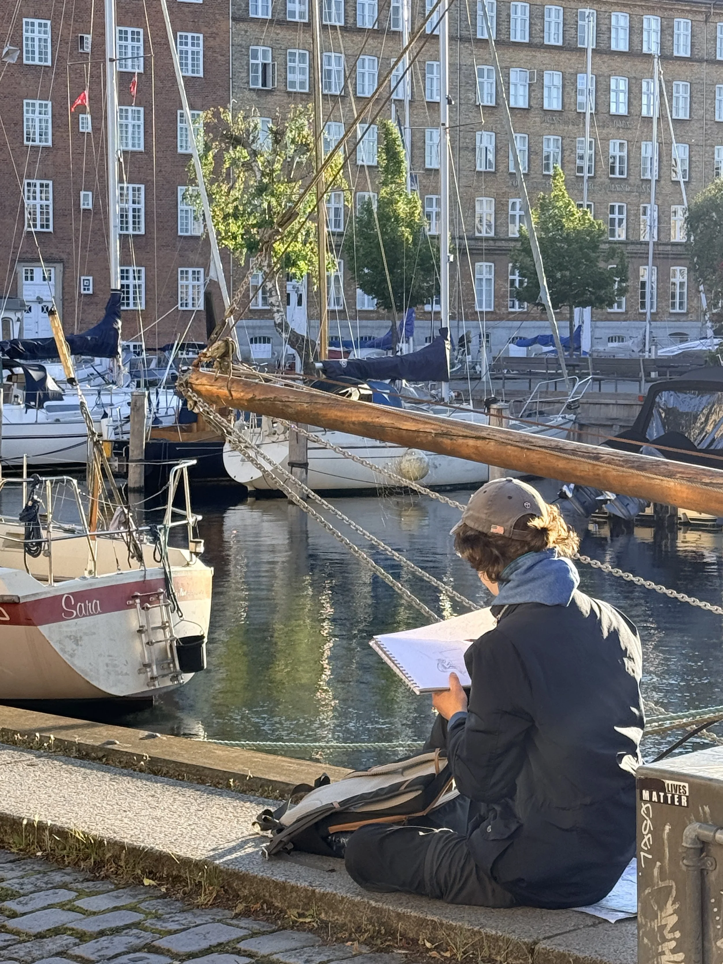 A person drawing on the banks of Copenhagen's canal