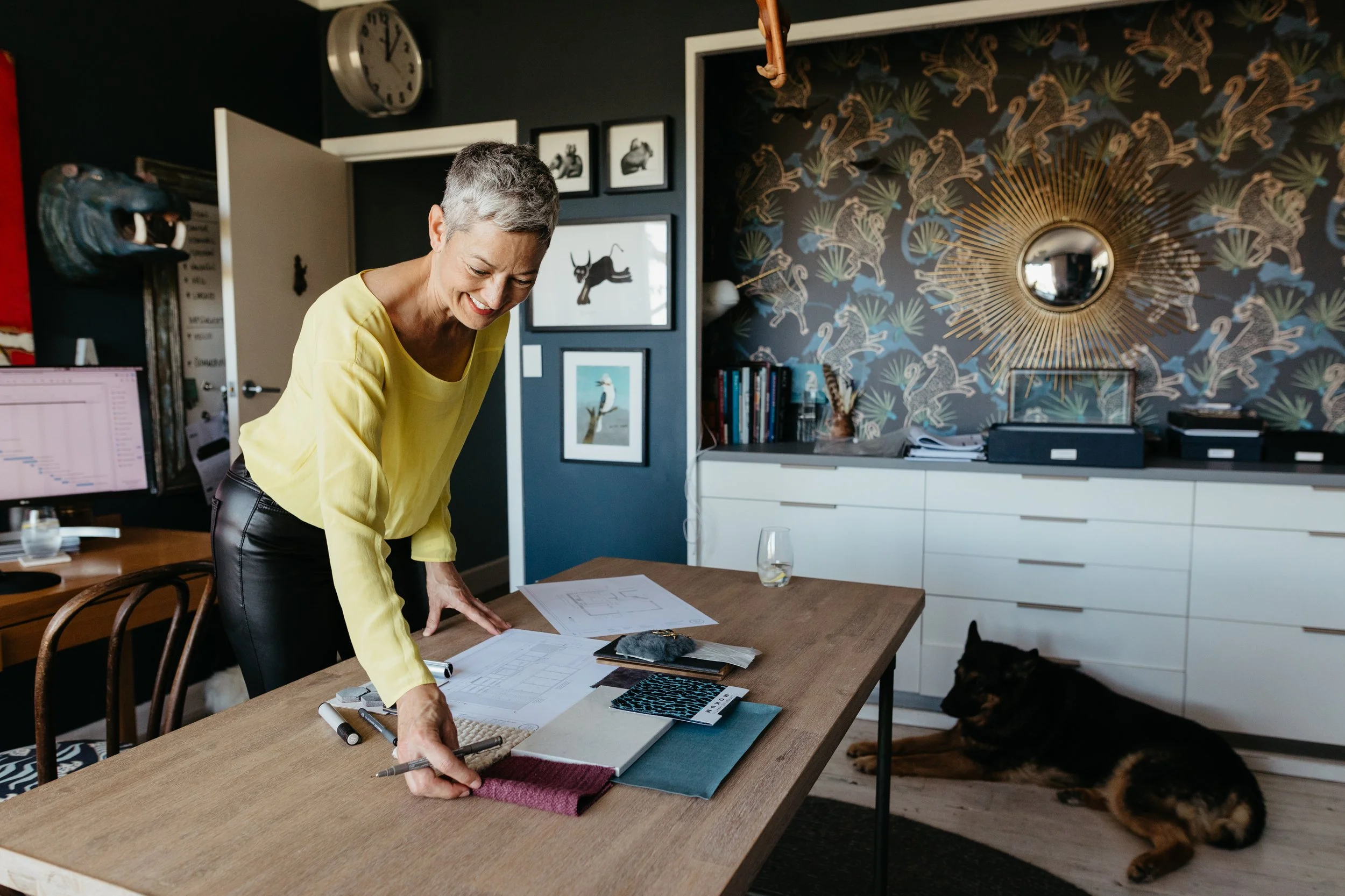 home office with deep blue walls and rustic timber table