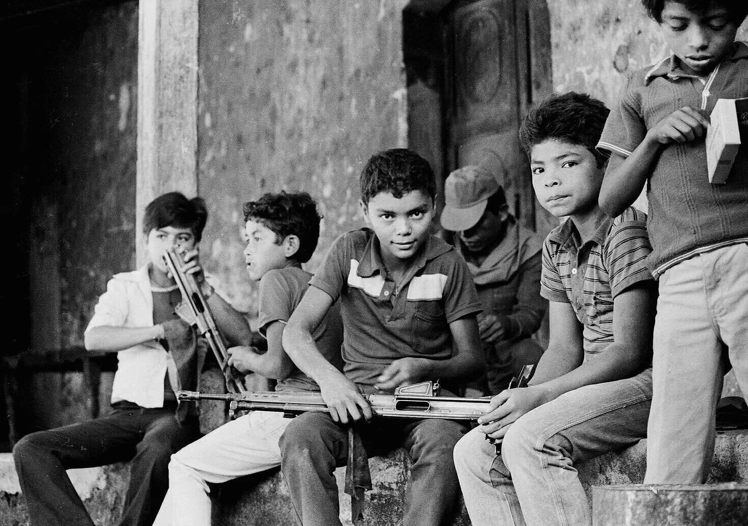 MORNING CHORES   —   cleaning the rifles used to defend the village from a guerrilla attack the previous night, San Sebastian