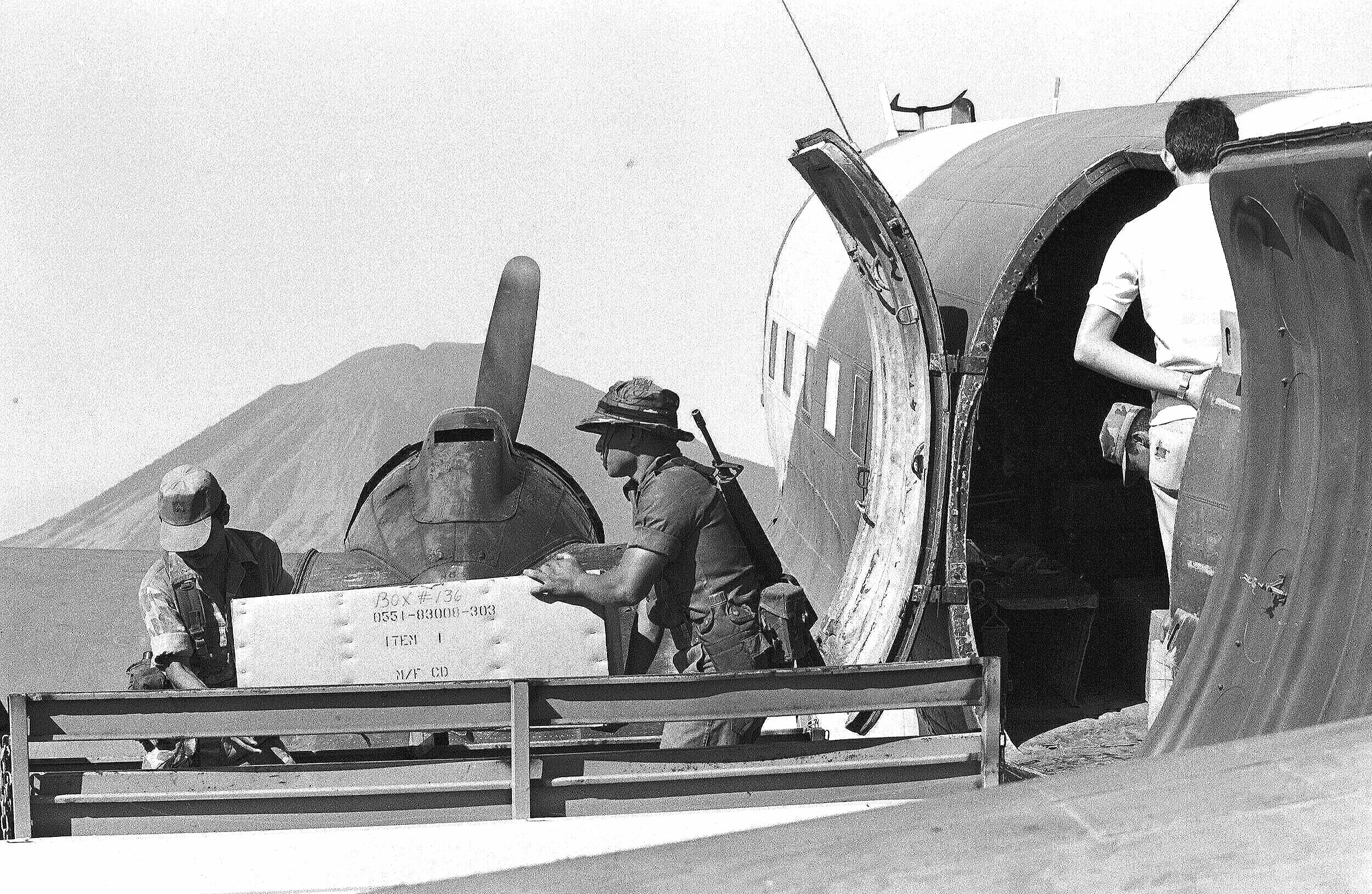 UNDER THE VOLCANO  —   unloading CIA donated arms (M-2 carbines) from a DC3,  San Miguel airfield