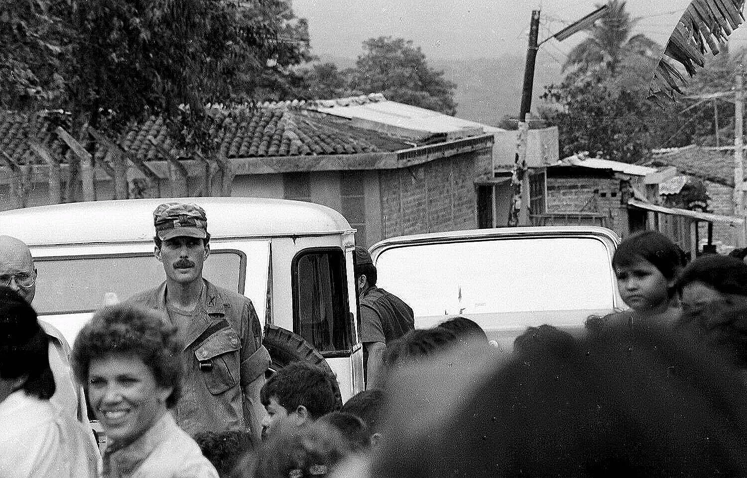 CHAOS AT THE REFUGEE CAMP    —      young American Green Beret advisor Captain Kevin Higgins,  San Vicente