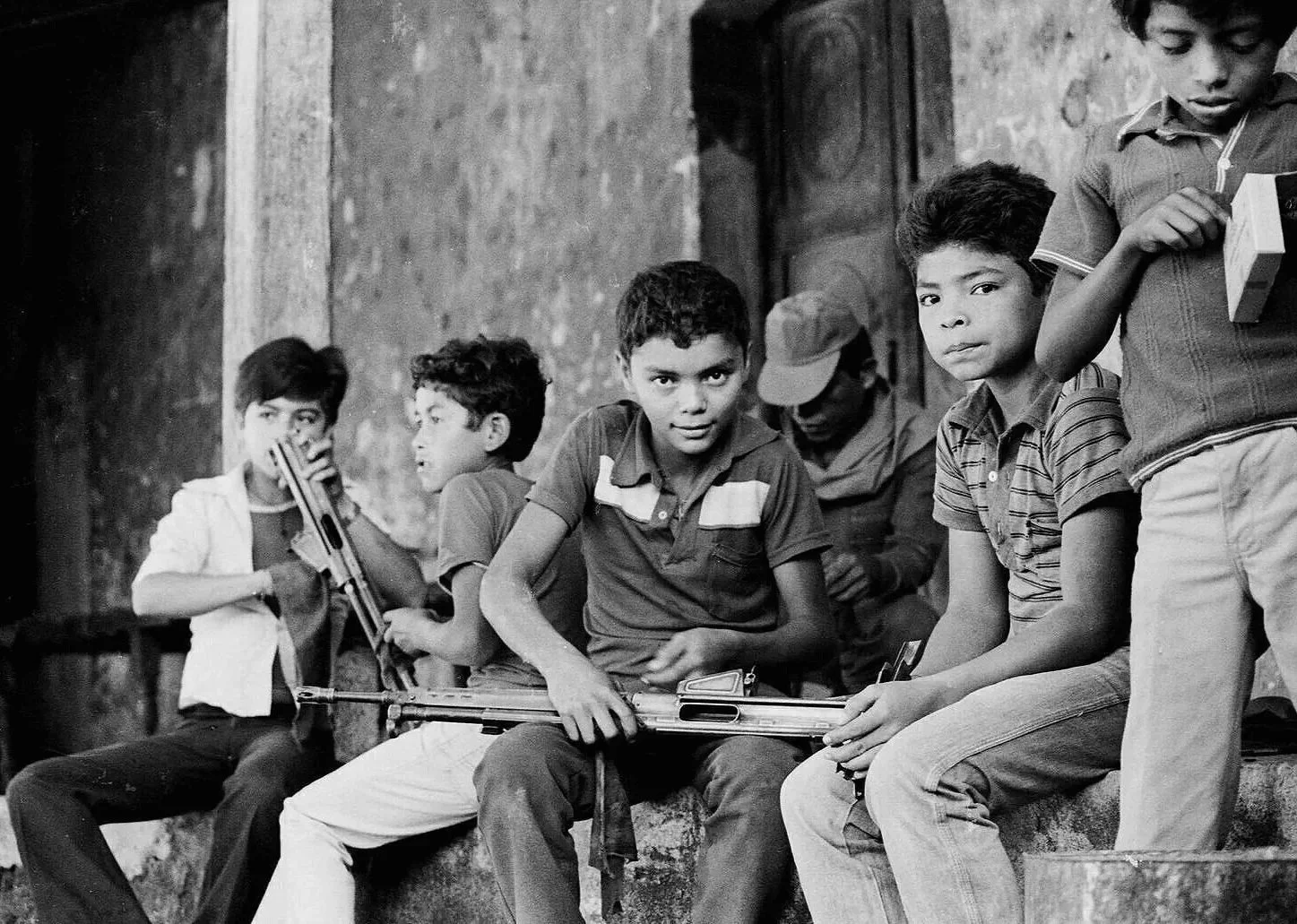 MORNING CHORES   —   cleaning the rifles used to defend the village from a guerrilla attack the previous night, San Sebastian