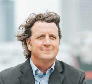 Smiling man with flowing hair in sport coat