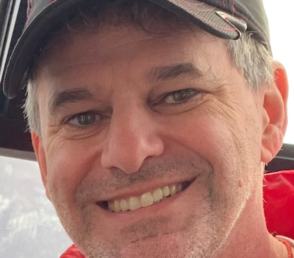 Smiling man in baseball cap