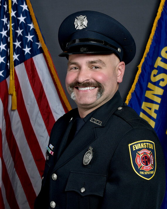 Sean Malloy in uniform with flag behind him