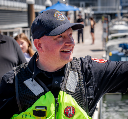 Smiling man in lifejacket and baseball hat