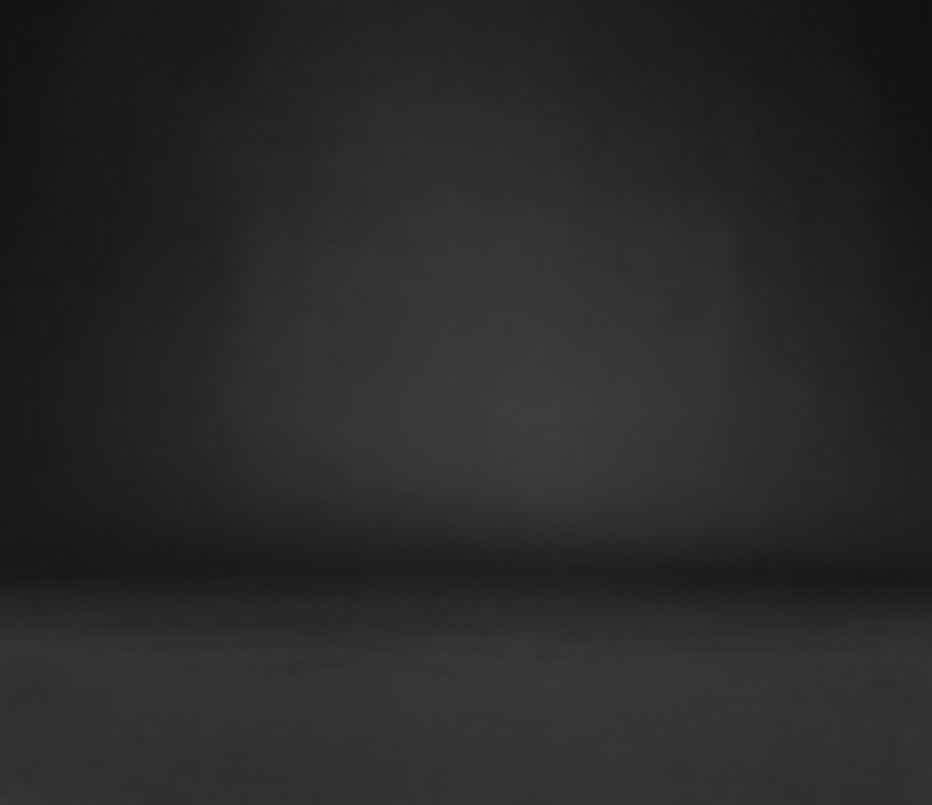 A dark, blurred background with a subtle gradient from darker at the edges to slightly lighter in the center.