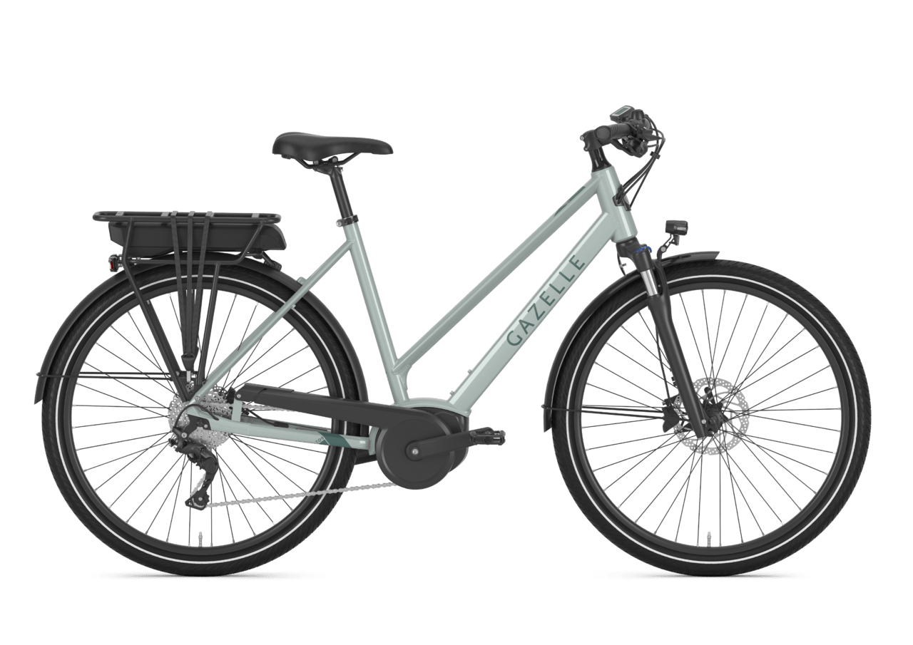 A gray Gazelle electric bicycle with black tires, a rear cargo rack, and disc brakes.