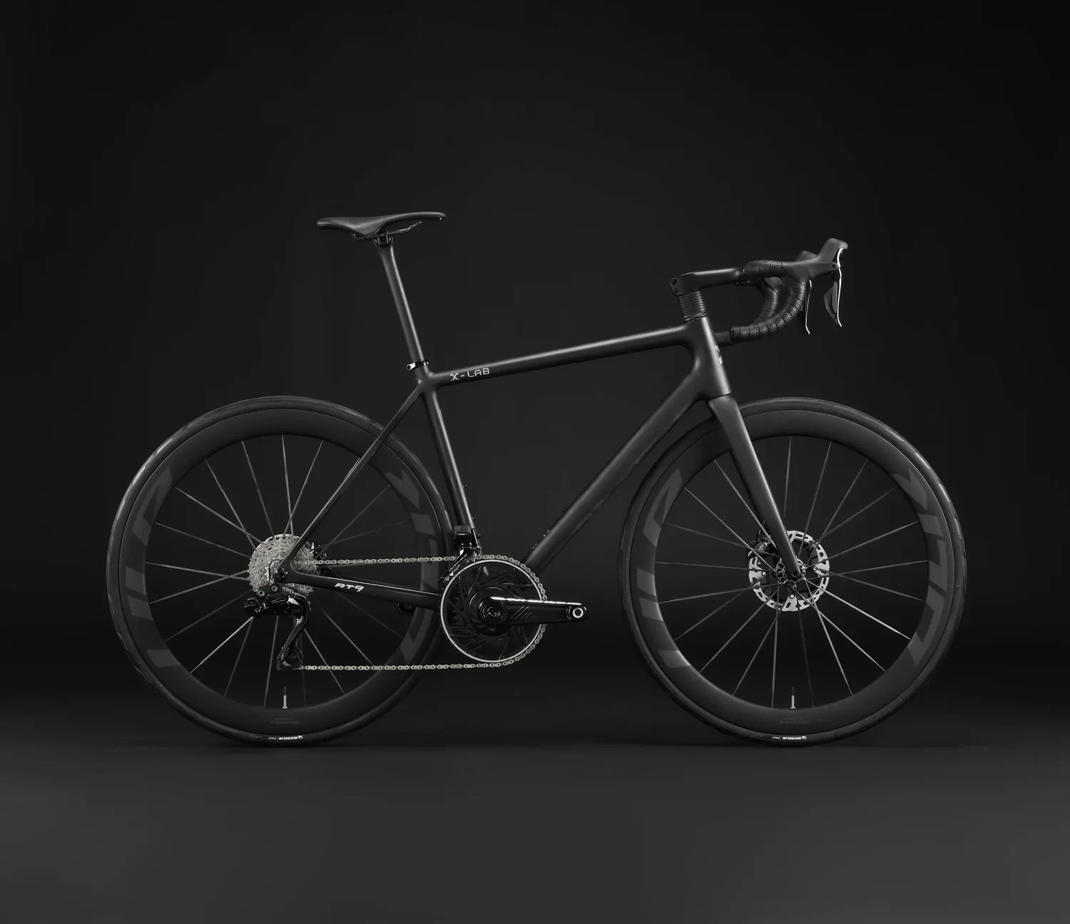 A sleek, black, modern road bicycle with disc brakes and aerodynamic deep-section wheels, displayed against a black background.