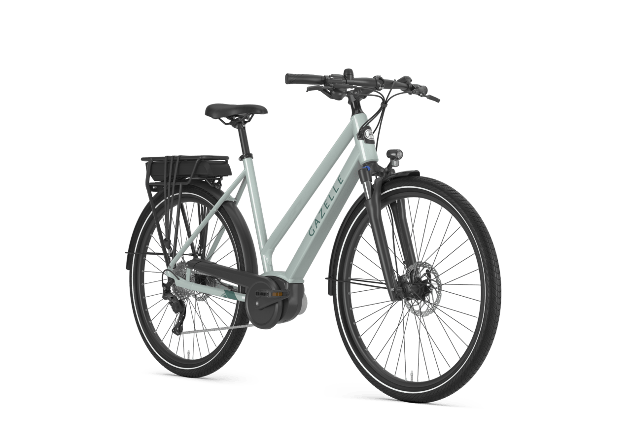 Electric bicycle with a sleek light-colored frame, black saddle, and black rear rack, isolated on a black background.