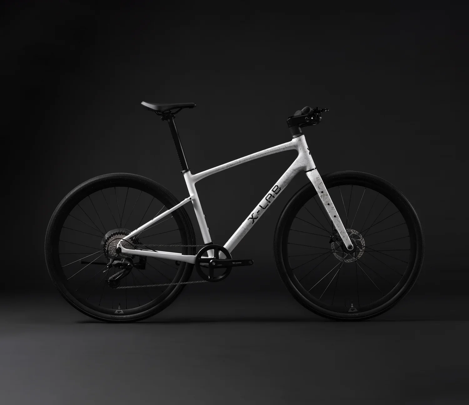 A sleek, modern white bicycle with black tires and a black seat, displayed against a dark background.