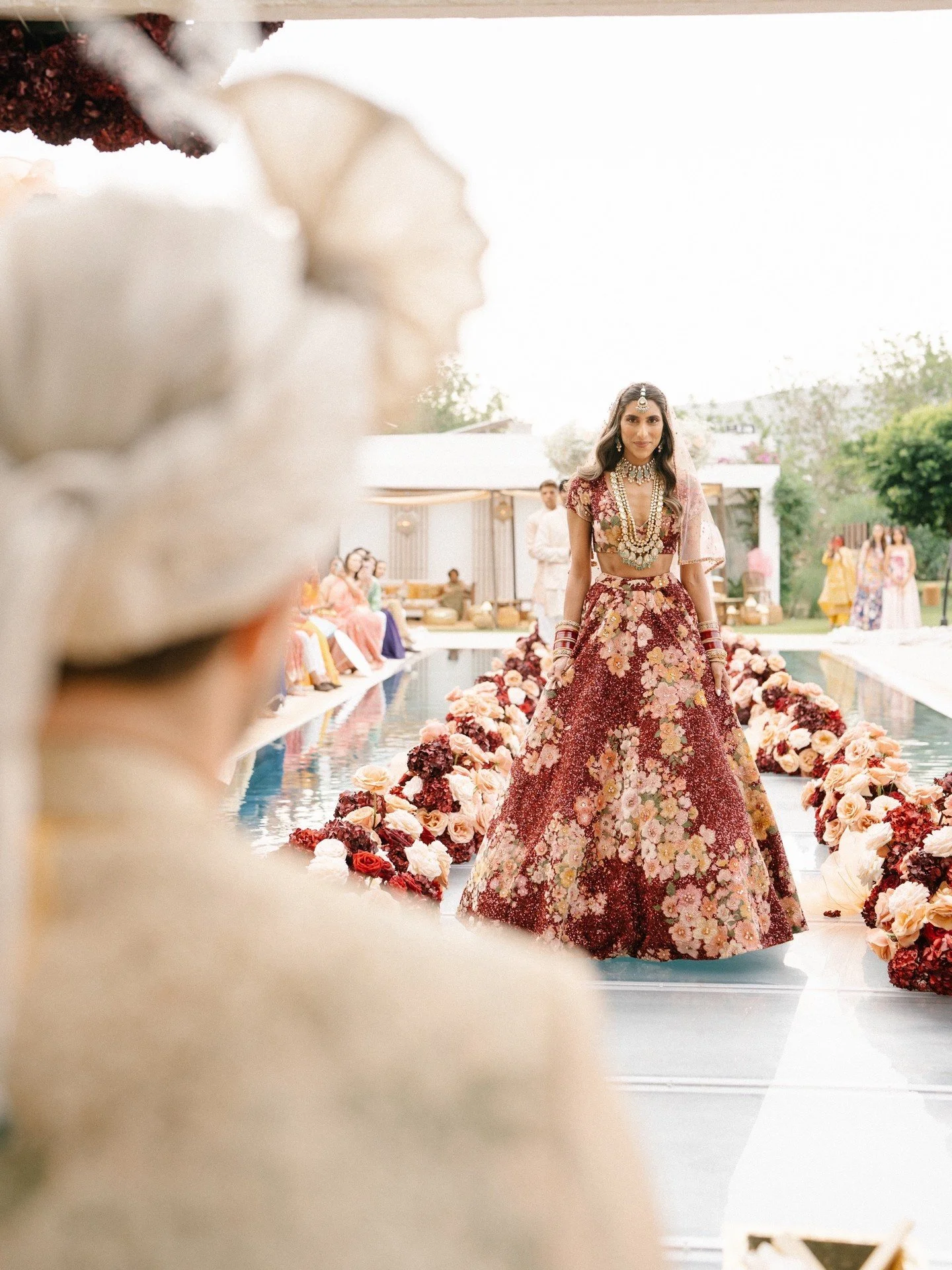 And here she comes &ndash; Tara, walking towards David, a moment everyone had been waiting for. A pathway of flowers, a poolside aisle, and a love story in full bloom.

Wedding Planner - @jcbespokeevents
Bride - @taraoberoi
Dresses - @galialahav / @b