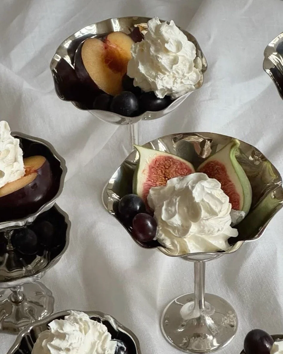 Fruit and whipped cream in silver cups.
That final touch the table deserves.
