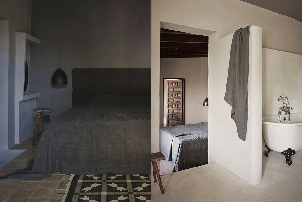 The image shows a bedroom with contrasting decor. On the left, the room has a dark, minimalist style with a dark bed, gray bedding, a small wooden stool, and a hanging pendant light. On the right, the room has a bright, rustic look with a similar bed