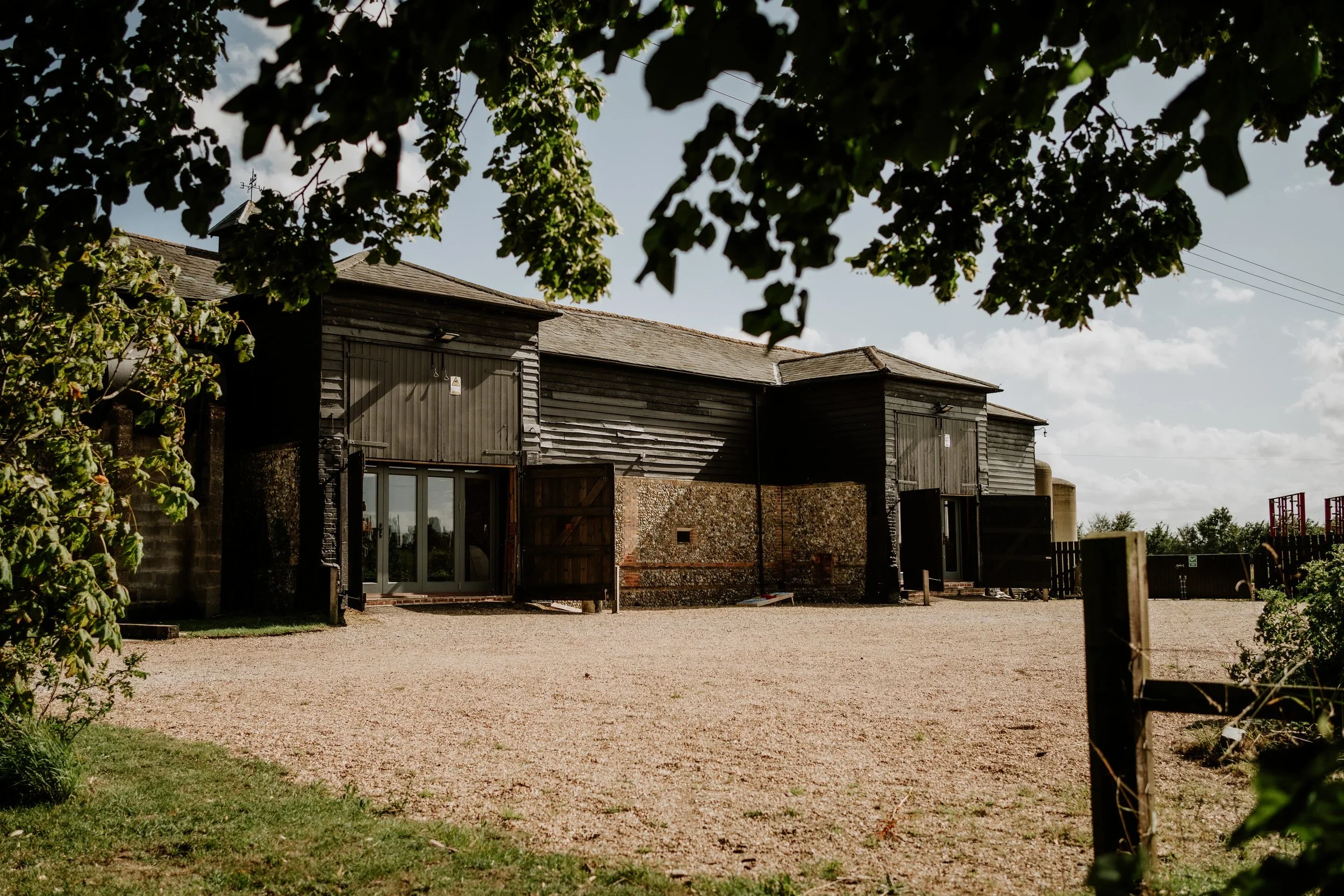 The Wedding Barn is a rustic barn with wooden and brick walls.