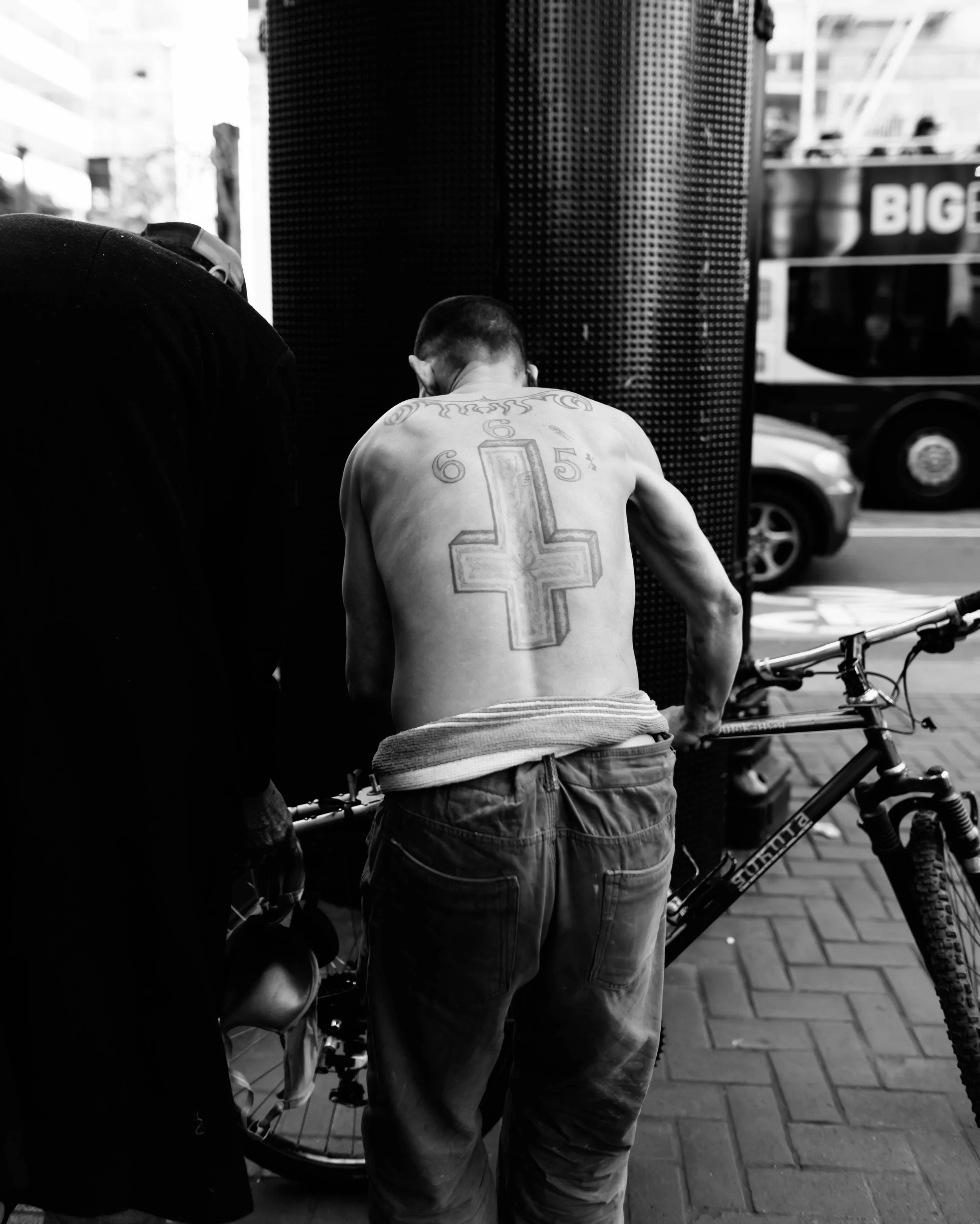 Cross tattoo on the back of a man in the financial district of San Francisco, California 
Photographed by Kyle Eagling 