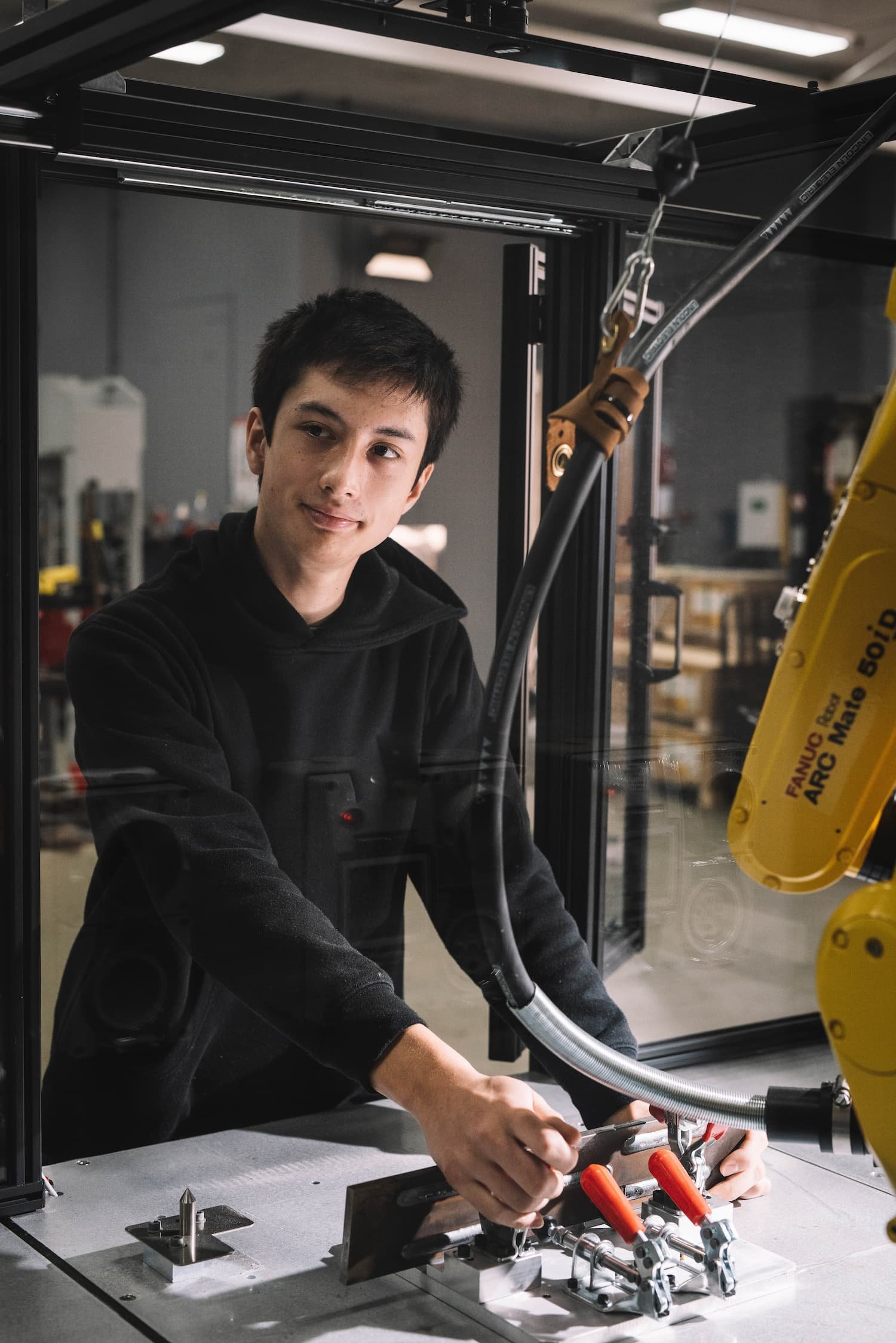 Person operating robotic equipment in a workshop
