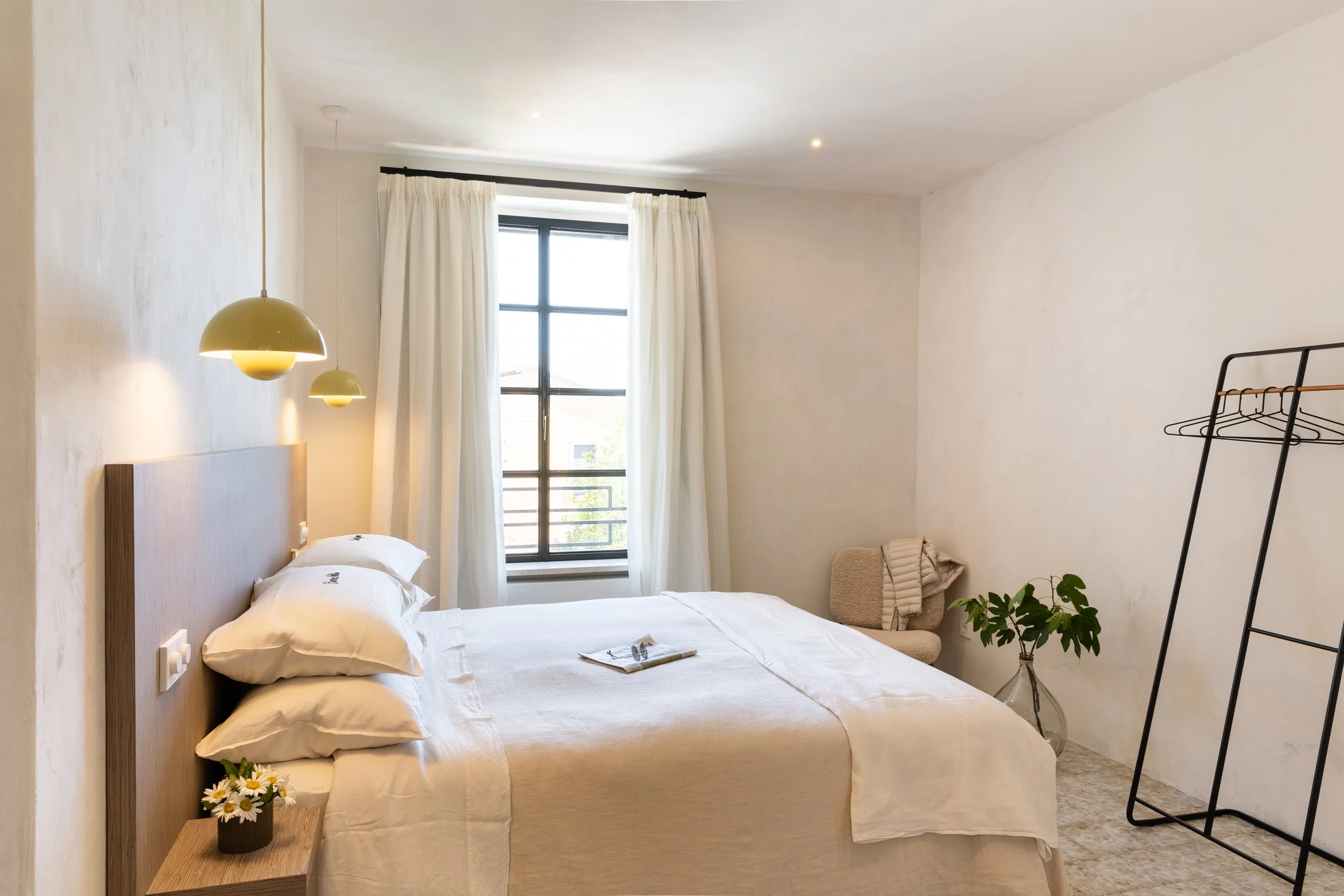 large white modern bedroom in sunny umbrian villa
