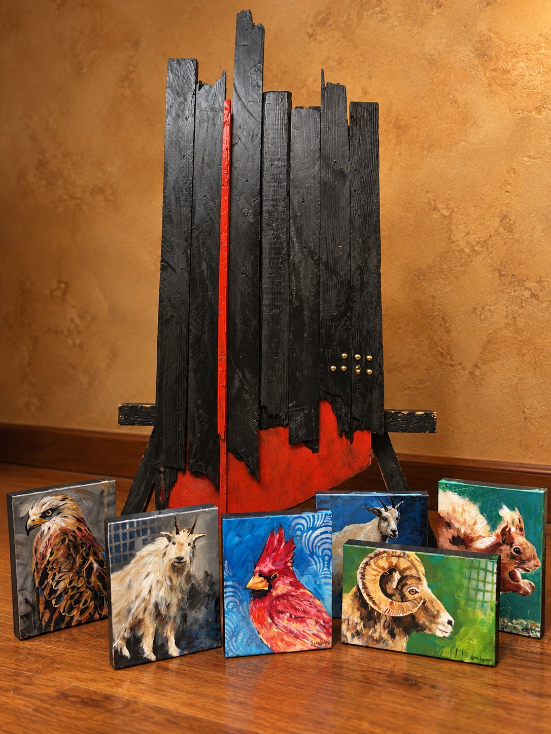 A wooden sculpture by Jim Burger and 5x7 animal portraits by Lyssa Lovejoy