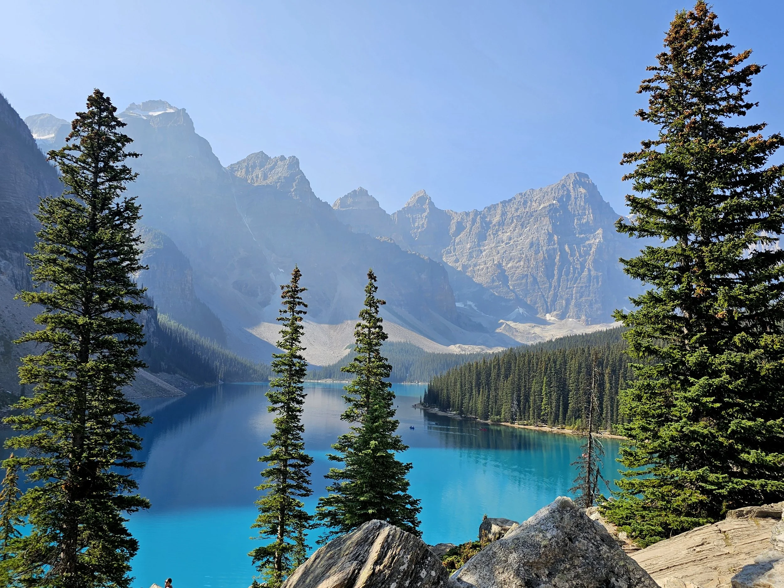 Mountains in the background with beautiful water and evergreens in the foreground