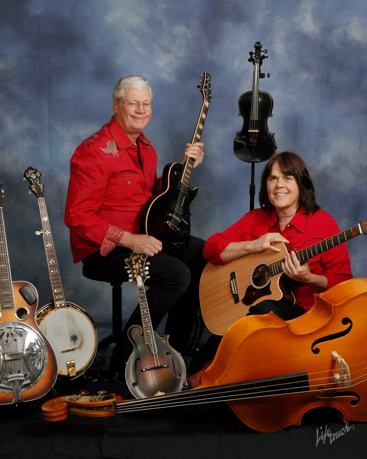 Jerry andShirley S[ahanks sit surrounded by stringed instruments