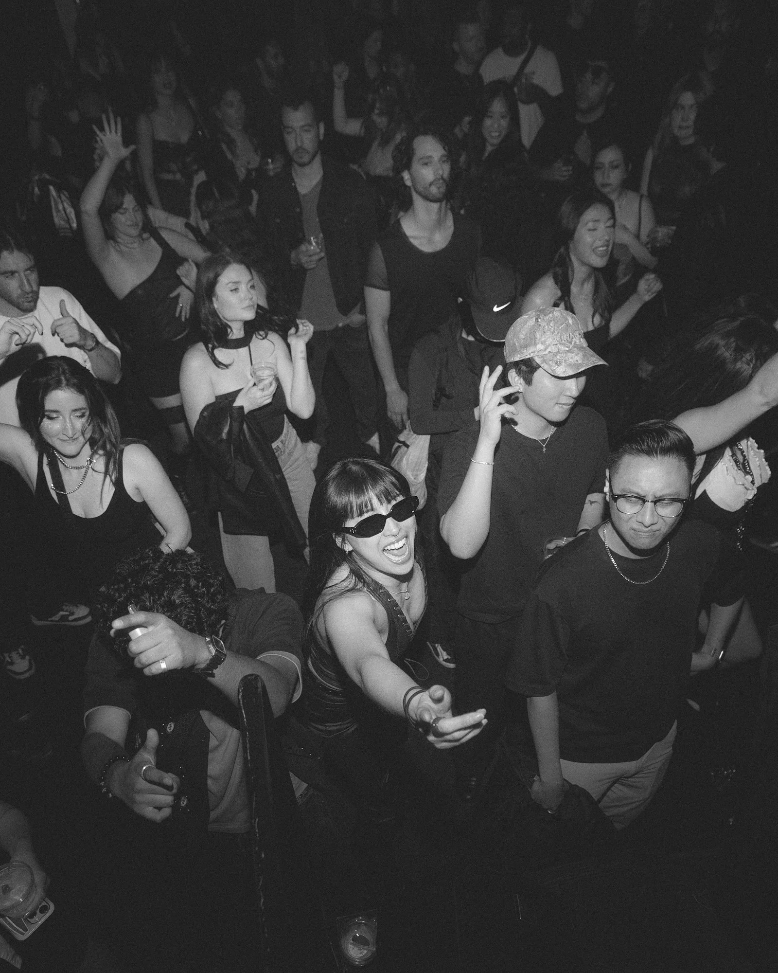 A group of young people enjoying a night out at a party or club, dancing and socializing.