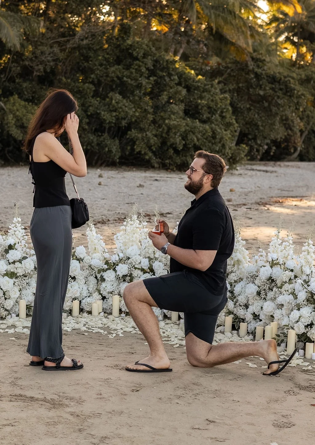 Port Douglas Proposal Photographer captured on the beach with romantic floral styling 