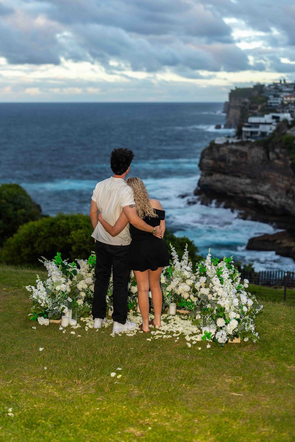 Romanic Set Up On Sydney Clifftop with white floral proposal set up captured by a proposal photographer