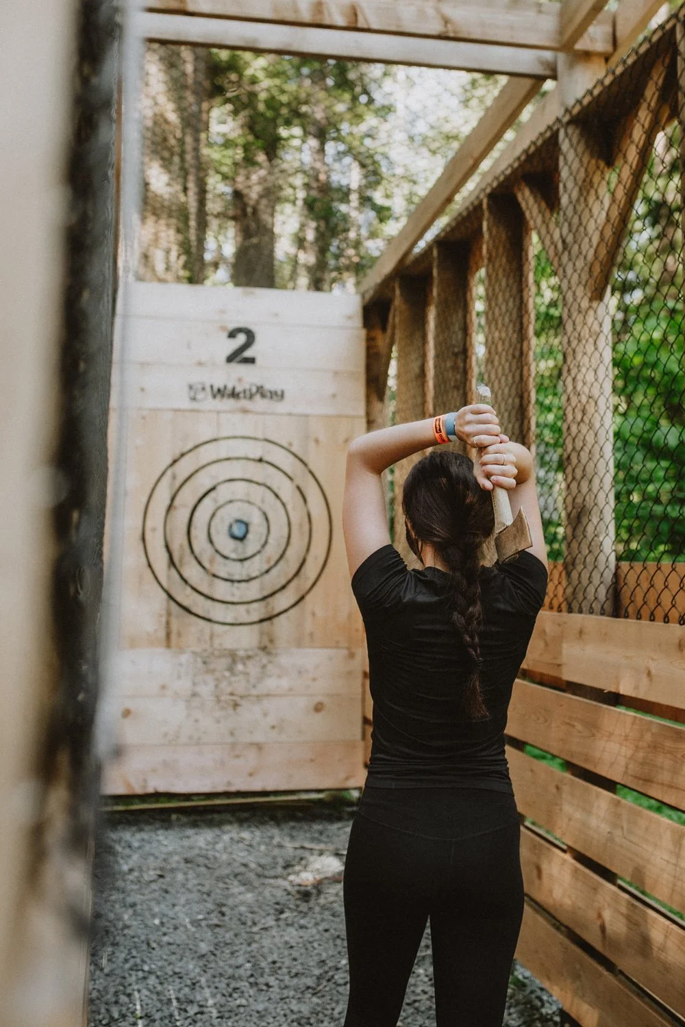 Guest preparing to throw an axe at WildPlay Victoria outdoor adventure park.