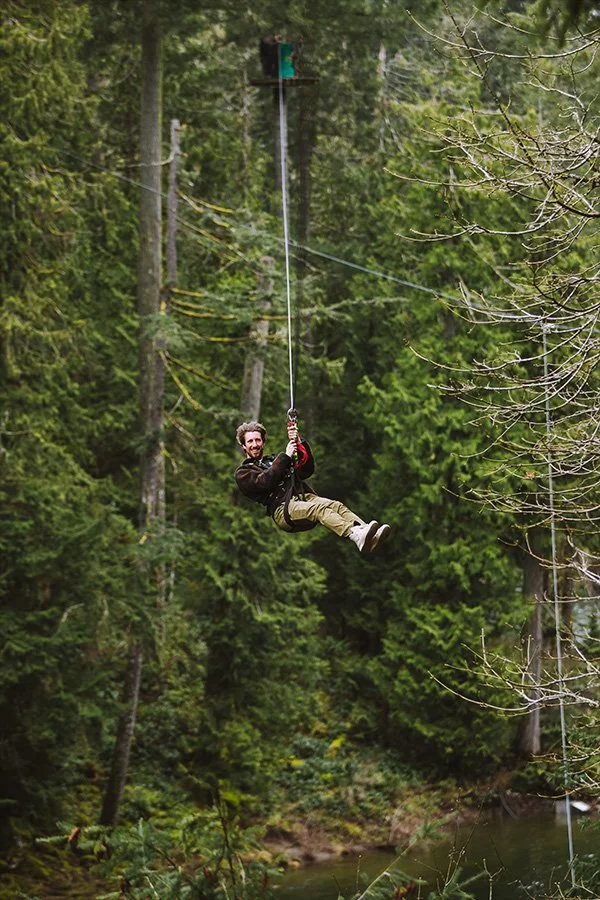 Guest ziplining ziptour between canyons above the nanaimo river at aerial adventure park WildPlay Nanaimo in British Columbia.
