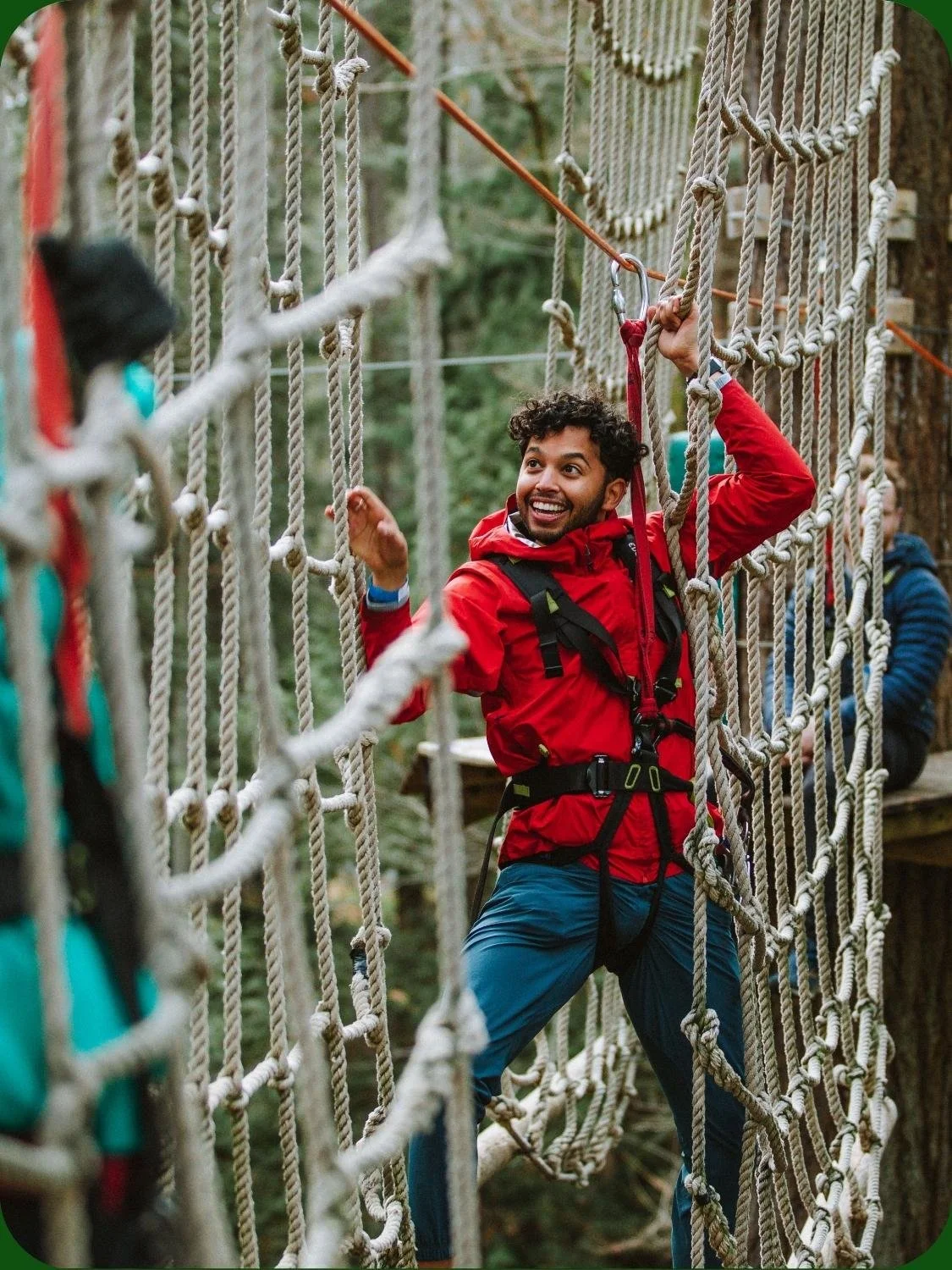 Man climbing on extreme adventure ropes course at WildPlay outdoor adventure park. 