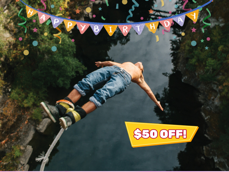 A man bungy jumping backwards off the bridge down towards the Nanaimo River. 