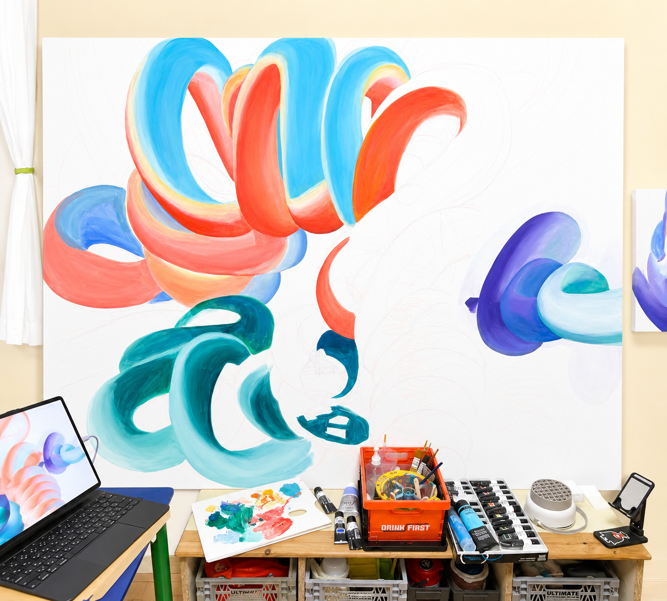 Finishing touches being added to an abstract, colorful mural of swirling shapes in shades of blue, teal, orange, and purple in an art studio.