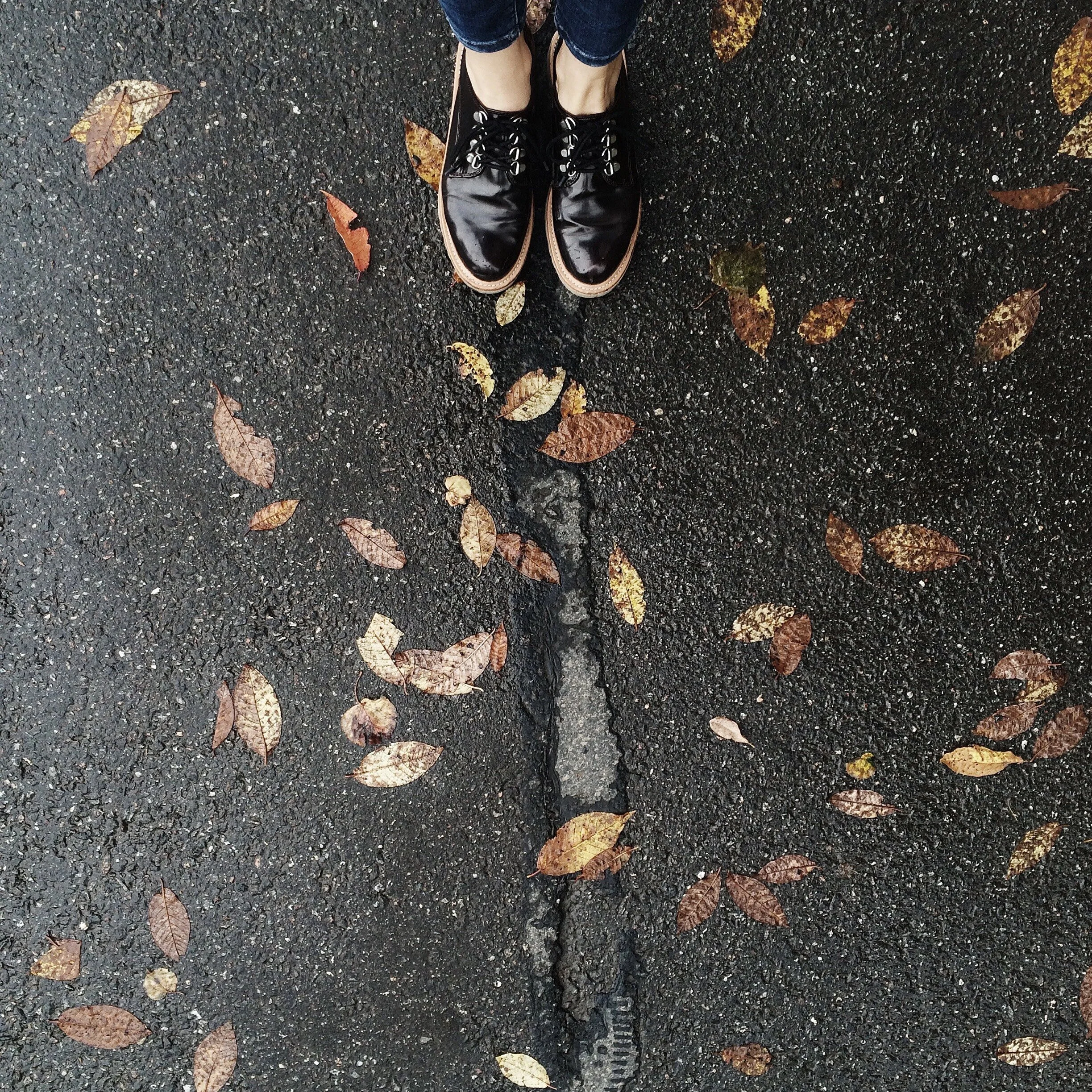 person-wearing-black-low-top-shoes-standing-concrete-1030939.jpg