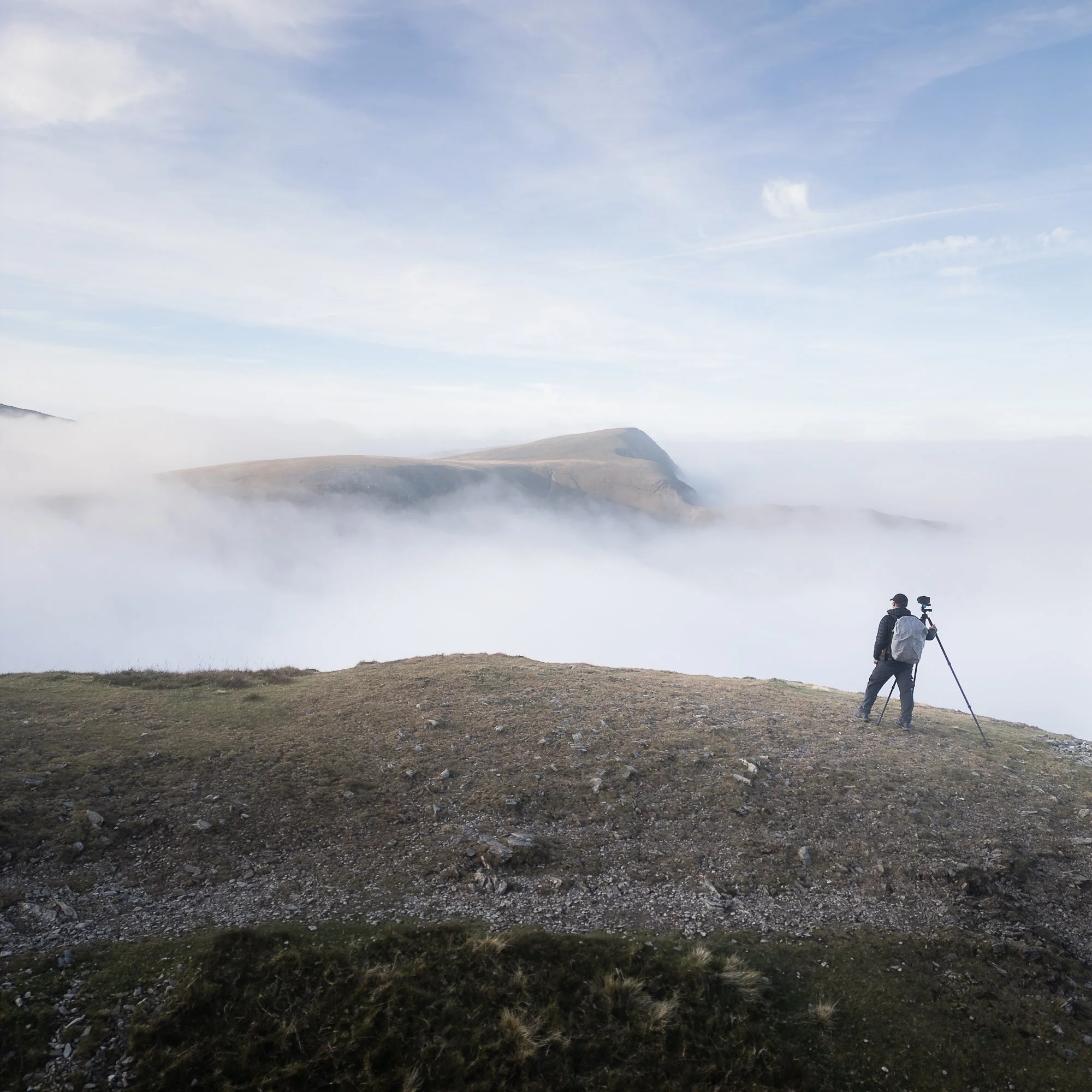 A drone photo of Trevor Sherwin standing on Y Garn in Snowdonia during a cloud inversion