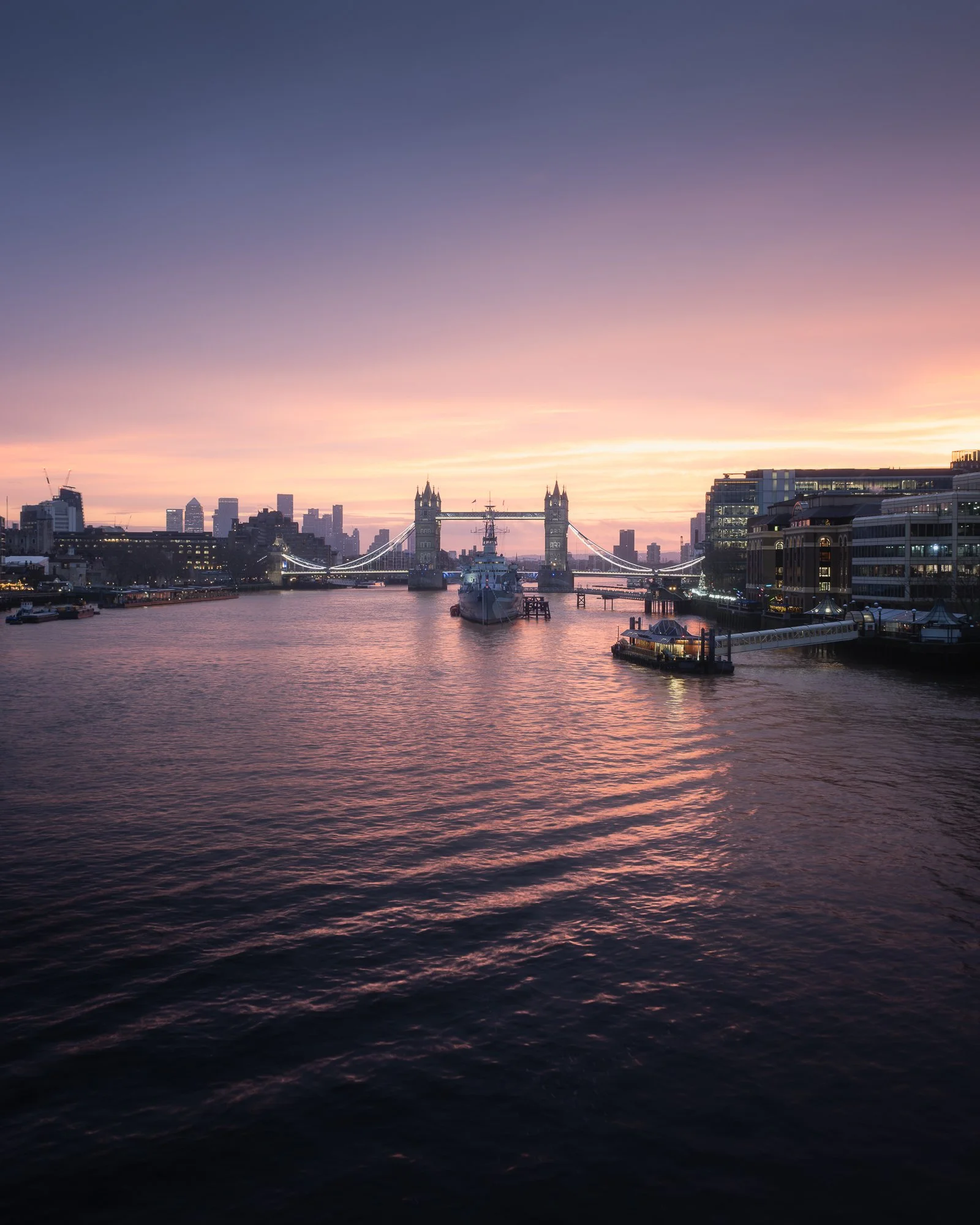 London cityscape at sunrise from London Bridge, featuring HMS Belfast and Tower Bridge