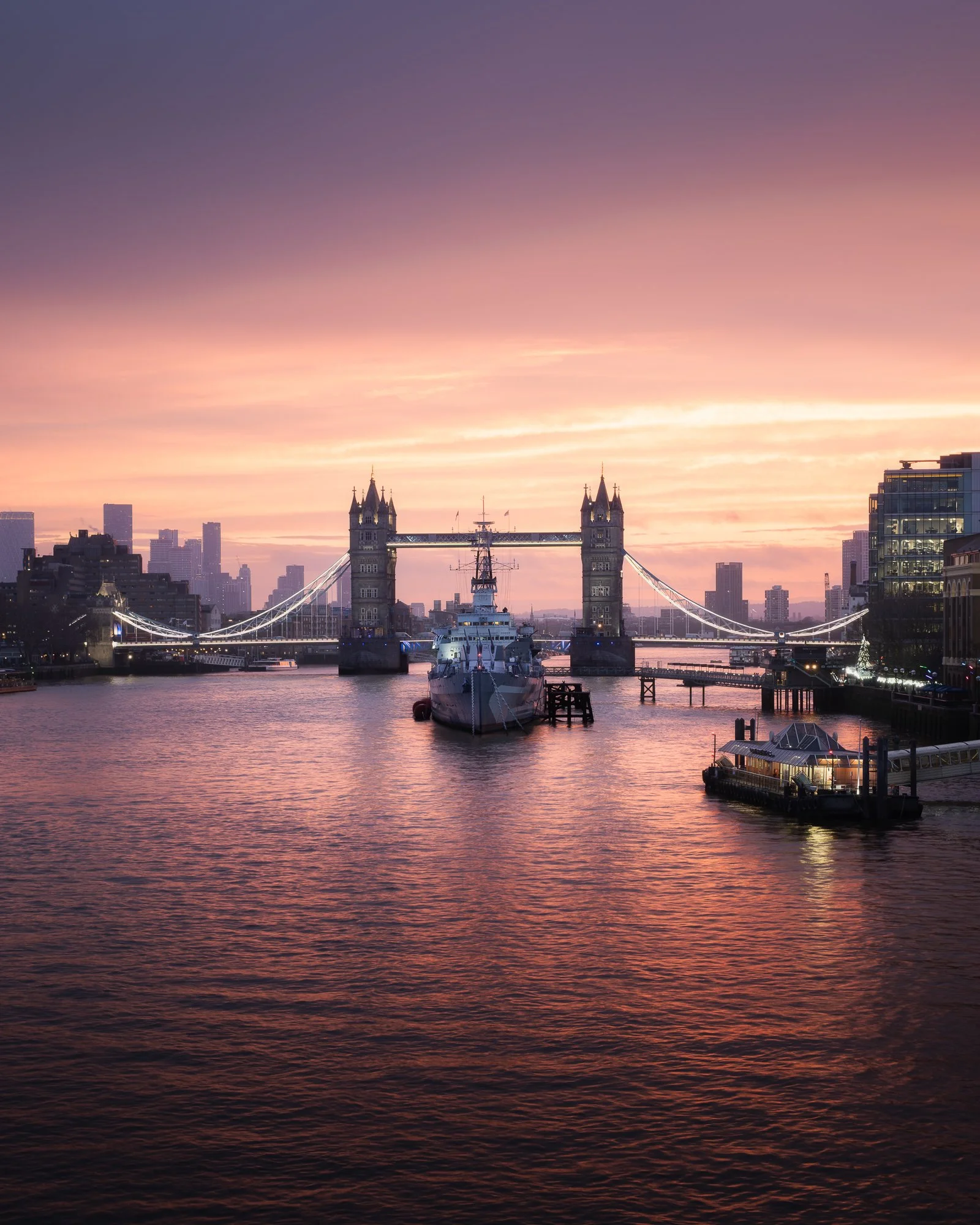 London cityscape at sunrise from London Bridge, featuring HMS Belfast and Tower Bridge