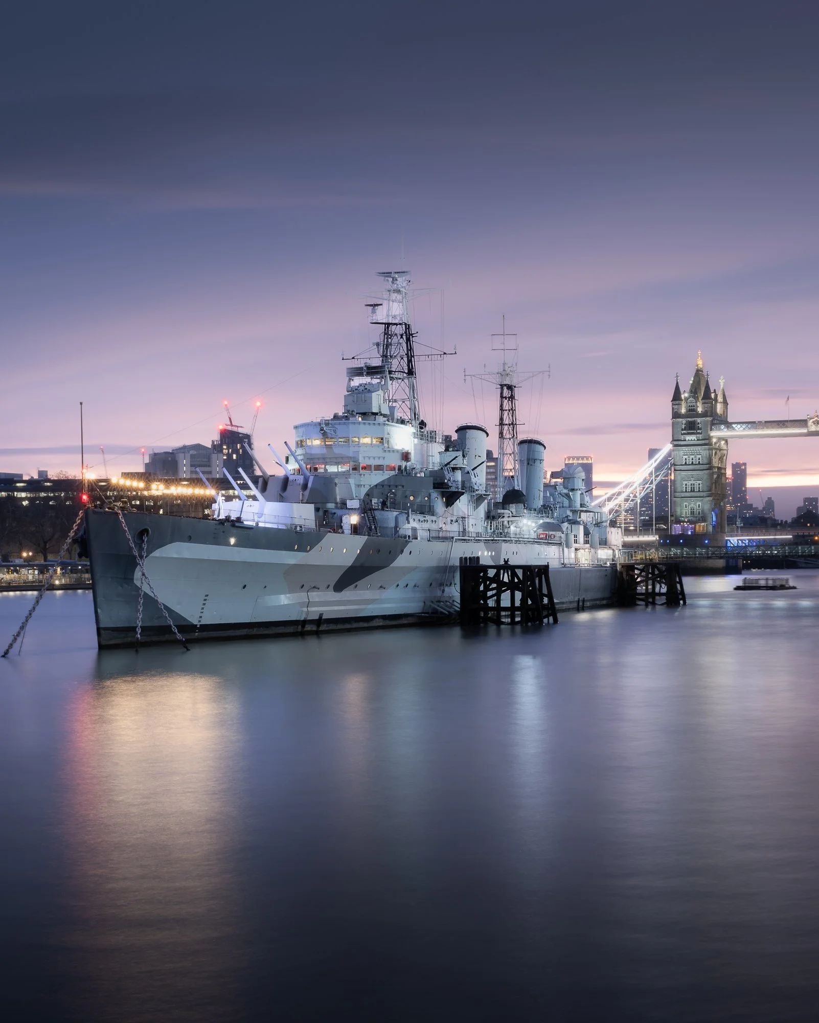 London cityscape at sunrise featuring HMS Belfast and Tower Bridge