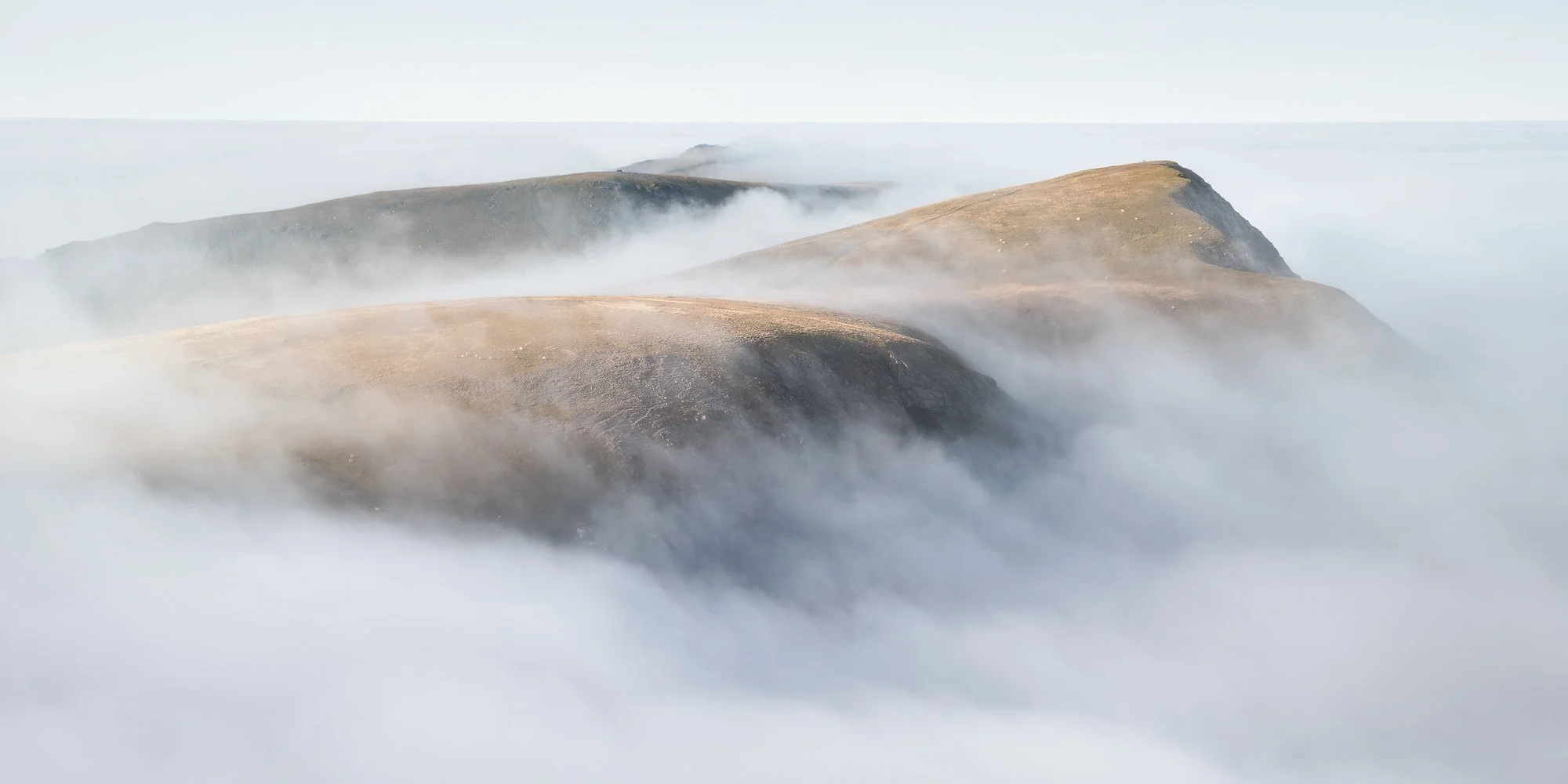The peaks of mountains exposed during a cloud inversion in Snowdonia taken by Trevor Sherwin